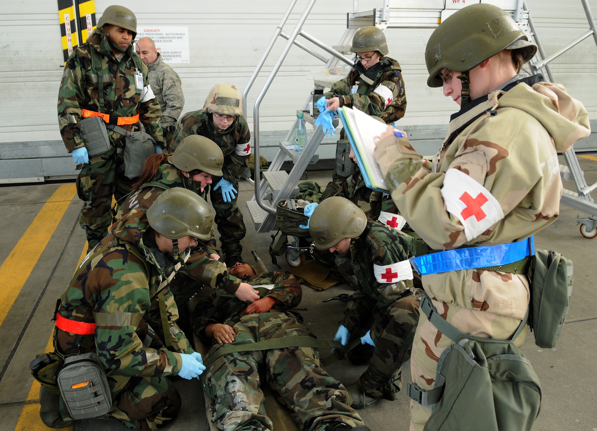 SPANGDAHLEM AIR BASE, Germany – Airman 1st Class Renae Hewes, 52nd Medical Support Squadron, creates a chart for a patient while other medical personnel simulate stabilizing a wounded Airman during Operation Saber Crown 10-04 here March 3. Members of the 52nd Fighter Wing participated in the Phase II exercise to evaluate the wing’s ability to operate in a chemical, biological, radiological, nuclear and explosive environment and to prepare the wing for the NATO force evaluation this summer. (U.S. Air Force photo/Senior Airman Nathanael Callon)