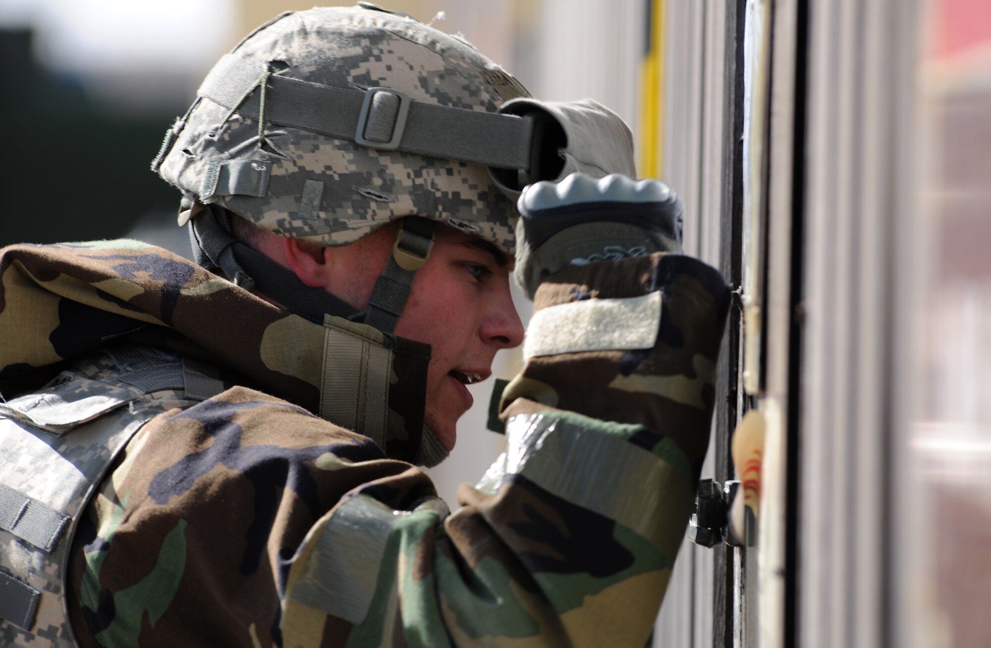 SPANGDAHLEM AIR BASE, Germany – Senior Airman Zachary Byrd, 52nd Security Forces Squadron, bangs on the door of the Medical Aid Station in search of assistance for a wounded Airman during Operation Saber Crown 10-04 here March 3. Members of the 52nd Fighter Wing participated in the Phase II exercise to evaluate the wing’s ability to operate in a chemical, biological, radiological, nuclear and explosive environment and to prepare the wing for the NATO force evaluation this summer. (U.S. Air Force photo/Senior Airman Nathanael Callon)