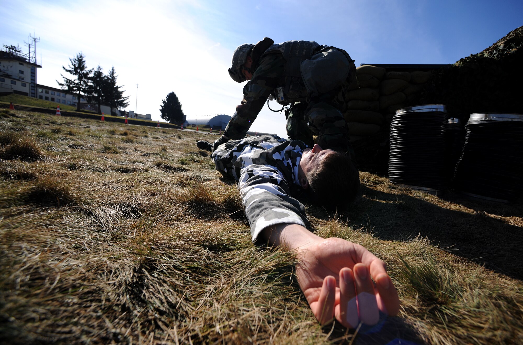 SPANGDAHLEM AIR BASE, Germany – Senior Airman Zachary Byrd, 52nd Security Forces Squadron, searches for weapons on the body of Senior Airman Cian Westmoreland, 606th Air Control Squadron, after Airman Byrd simulated use of deadly force to prevent the sabotage of assets on the flightline during Operation Saber Crown 10-04 here March 3. Members of the 52nd Fighter Wing participated in the Phase II exercise to evaluate the wing’s ability to operate in a chemical, biological, radiological, nuclear and explosive environment and to prepare the wing for the NATO force evaluation this summer. (U.S. Air Force photo/Senior Airman Nathanael Callon)