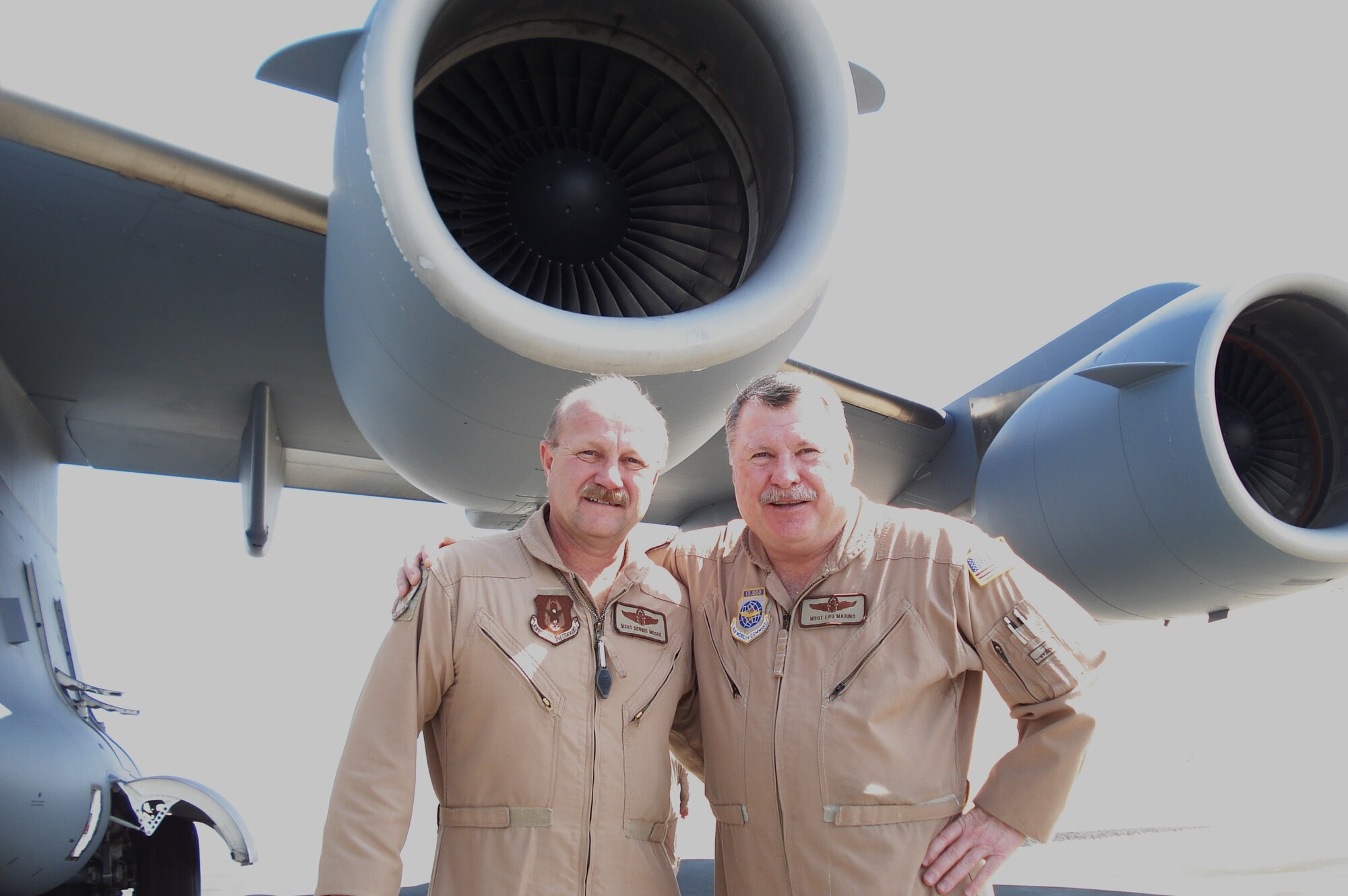 Master Sgt. Lou Marino(right), a loadmaster with the 701st Airlift Squadron, Charleston AFB, S.C., poses with Master Sgt. Dennis Moore on the ramp at Ramstein AB, Germany.