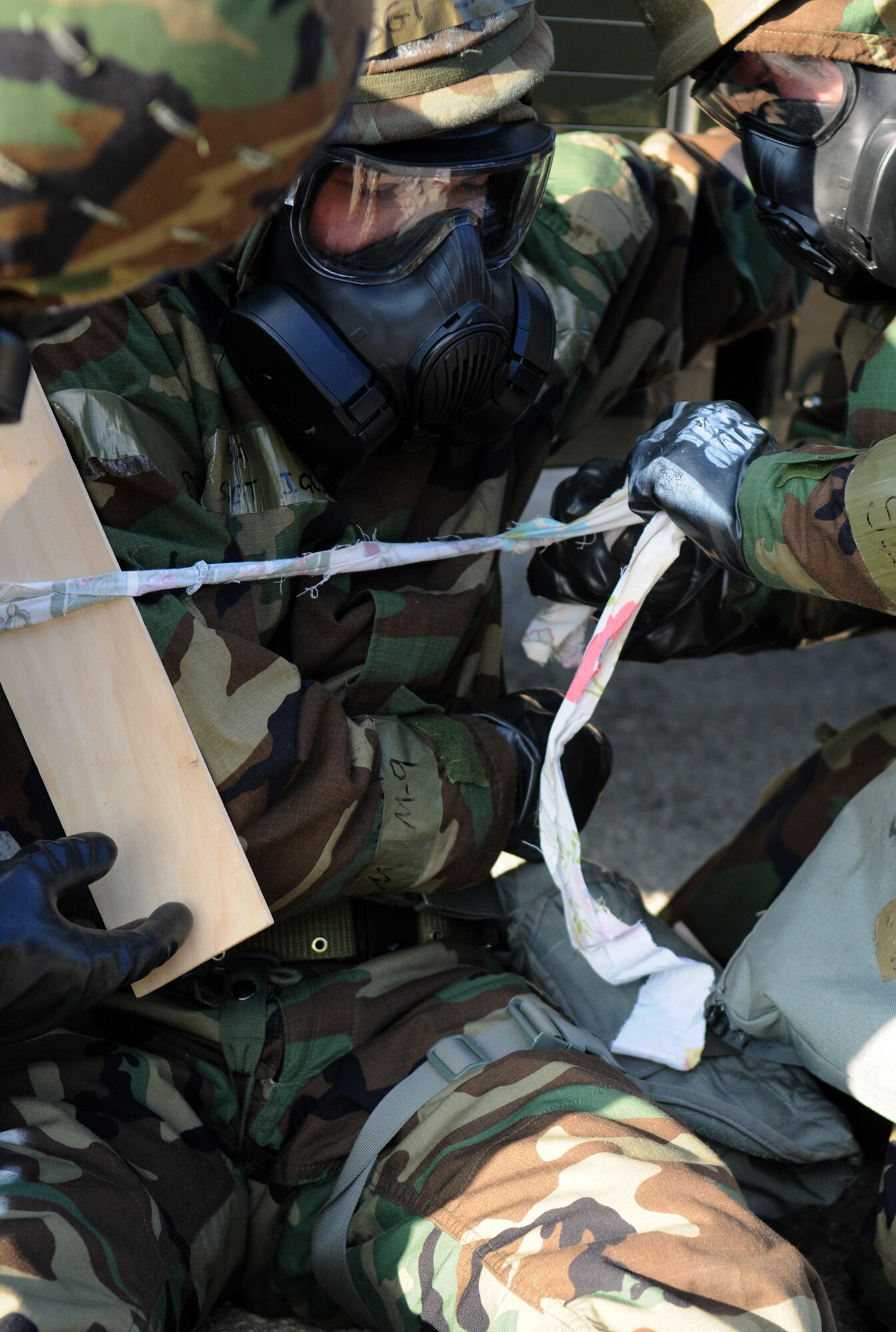 SPANGDAHLEM AIR BASE, Germany – Staff Sgt. John Quigley waits for his arm to be splinted before being transported to the Medical Aid Station during Operation Saber Crown 10-04 here March 3. During the Phase II exercise, Airmen were tested on self-aid and buddy care knowledge and the ability to operate in a chemical, biological, radiological, nuclear and explosive environment and to prepare the wing for the NATO force evaluation this summer. (U.S. Air Force photo/Senior Airman Nathanael Callon)