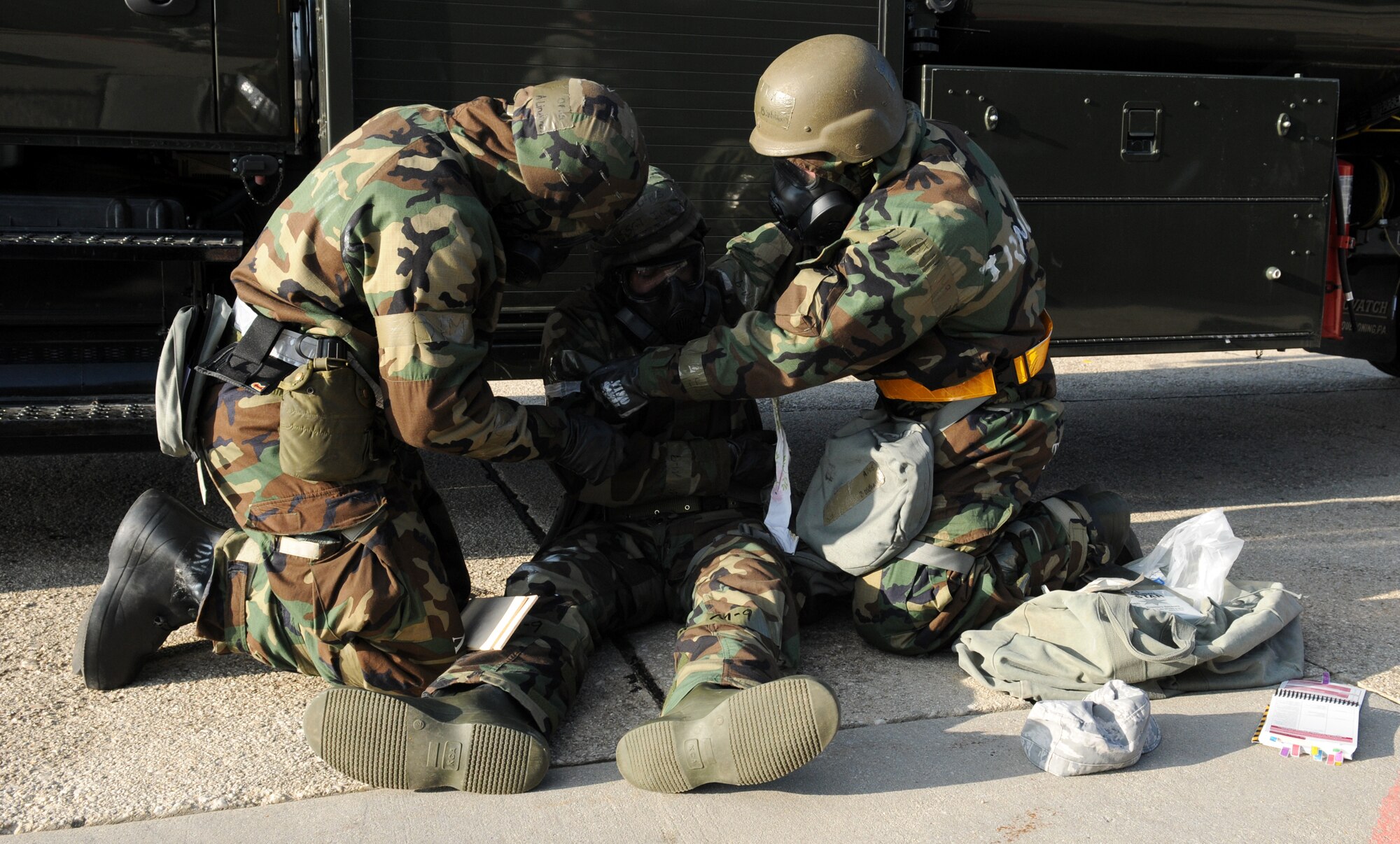 SPANGDAHLEM AIR BASE, Germany – Airman 1st Class Alan Lindgren and Senior Airman Brody Williams, 52nd Logistics Readiness Squadron, splint the arm of Staff Sgt. John Quigley, 52nd LRS, after a simulated mortar attack during Operation Saber Crown 10-04 here March 3. The simulation tested self-aid and buddy care knowledge and the ability to operate in a chemical, biological, radiological, nuclear and explosive environment and to prepare the wing for the NATO force evaluation this summer. (U.S. Air Force photo/Senior Airman Nathanael Callon)