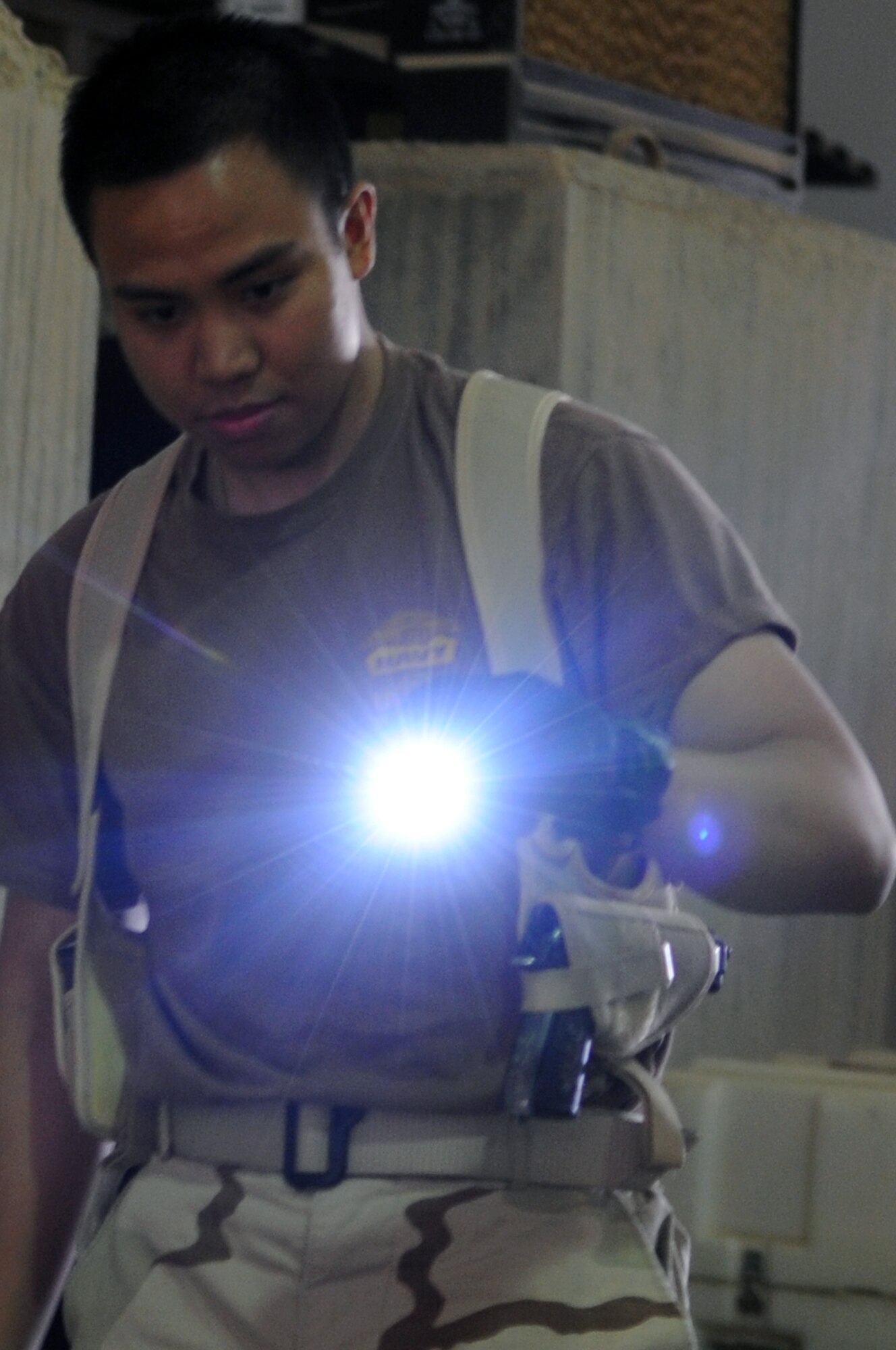 Petty Officer 2nd Class Jason Calugcugan inspects cargo for contraband and agriculture before it is shipped out of the area of responsibility at Joint Base Balad, Iraq, Feb. 27, 2010. PO2 Calugcugan is a customs border clearance agent with the Naval Expeditionary Logistics Support Group Delta Company, and a native of Gilbert, Arizona who is deployed from the Navy Operational Support Center in Phoenix. (U.S. Air Force photo/Senior Airman Brittany Y. Bateman/Released)