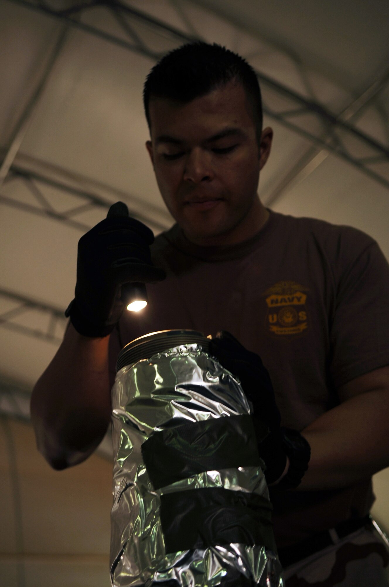 Petty Officer 3rd Class Pablo Garcia inspects cargo for contraband and agriculture before it is shipped out of the area of responsibility at Joint Base Balad, Iraq, Feb. 27, 2010. PO3 Garcia is a customs border clearance agent with the Naval Expeditionary Logistics Support Group Delta Company, and a native of White Plains, N.Y., who is deployed from the Navy Operational Support Center in the Bronx. (U.S. Air Force photo/Senior Airman Brittany Y. Bateman/Released)
