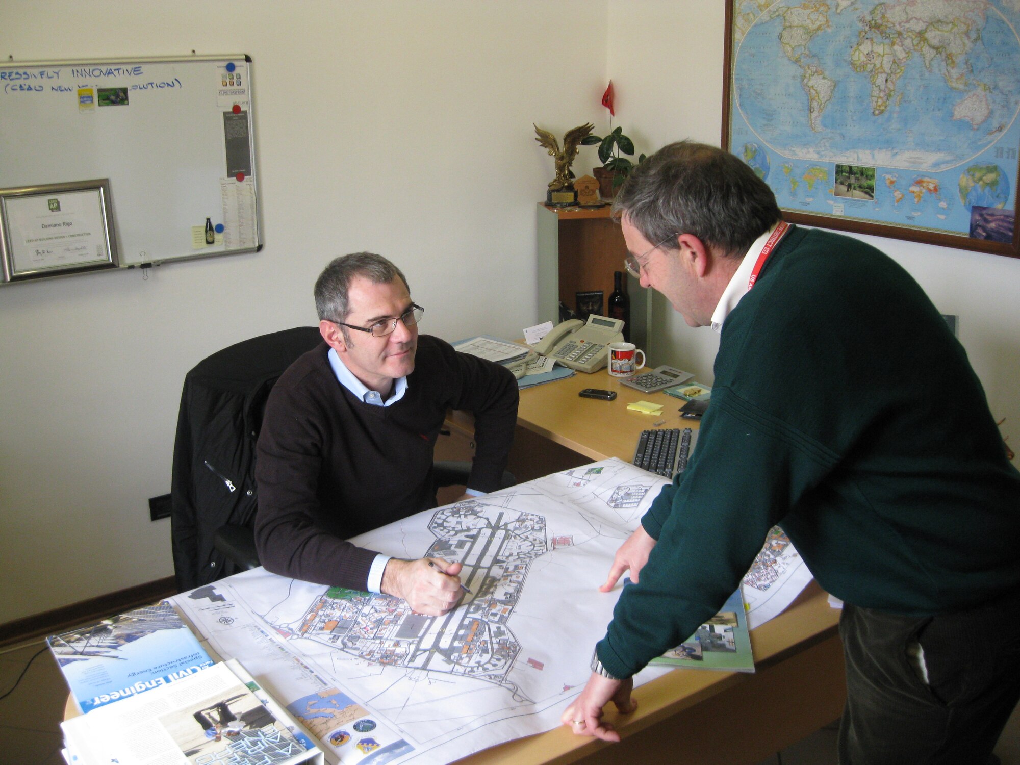 Damiano Rigo, 31st Civil Engineer Squadron asset optimization element chief, left, speaks with Danilo Gant, 31st Civil Engineer Squadron chief of NATO support, March 3, 2010 about upcoming projects planned at Aviano Air Base, Italy. (U.S. Air Force photo/2nd Lt. Brian Wagner)
