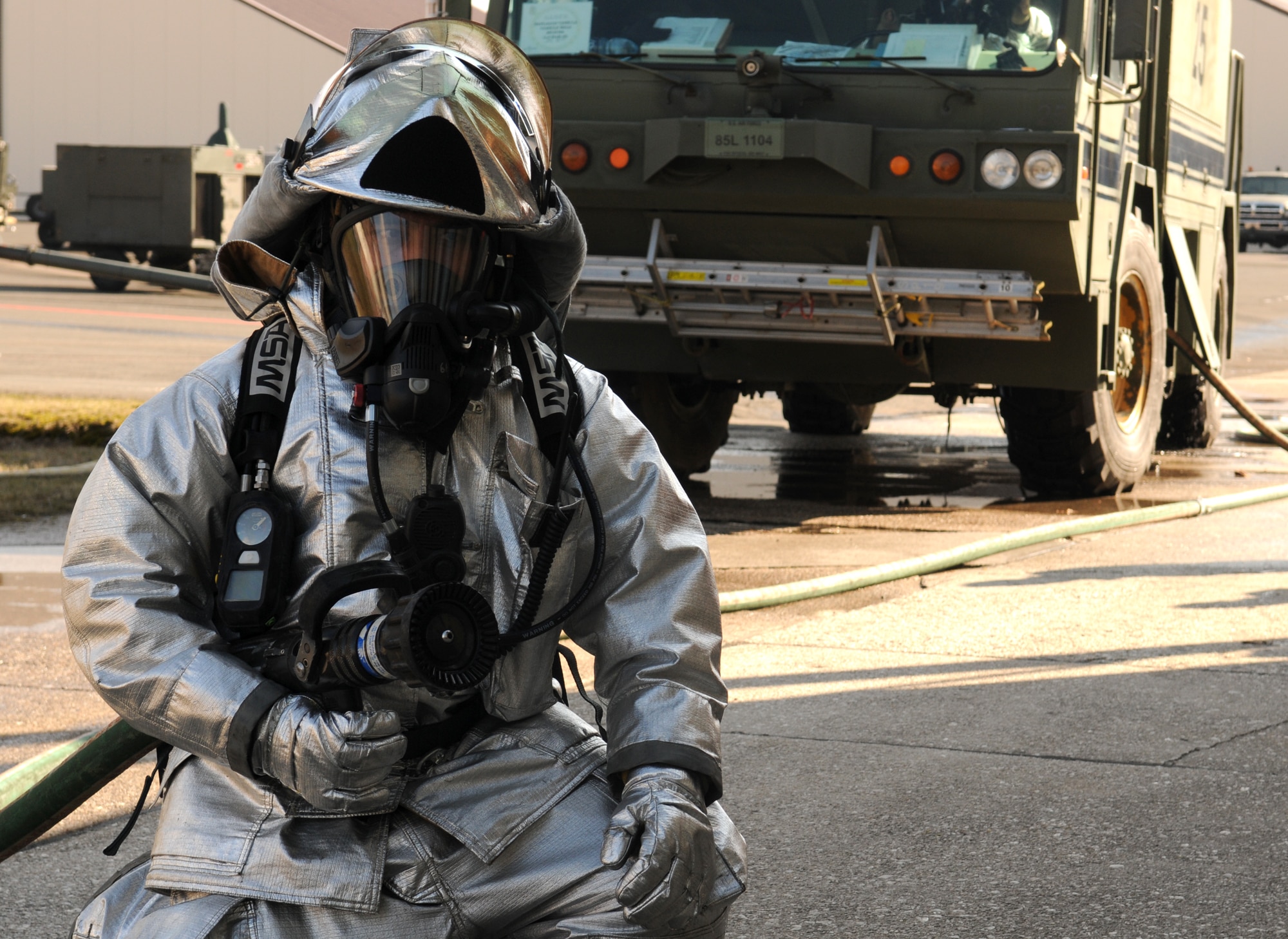 SPANGDAHLEM AIR BASE, Germany – Staff Sgt. Carlito Tacbas, 52nd Civil Engineer Squadron firefighter, prepares to enter a smoke-filled building during a simulated fire here March 2. Members of the 52nd Fighter Wing participated in Operation Saber Crown 10-04 to evaluate the wing’s ability to operate in a chemical, biological, radiological and nuclear environment. (U.S. Air Force photo/Senior Airman Nathanael Callon)