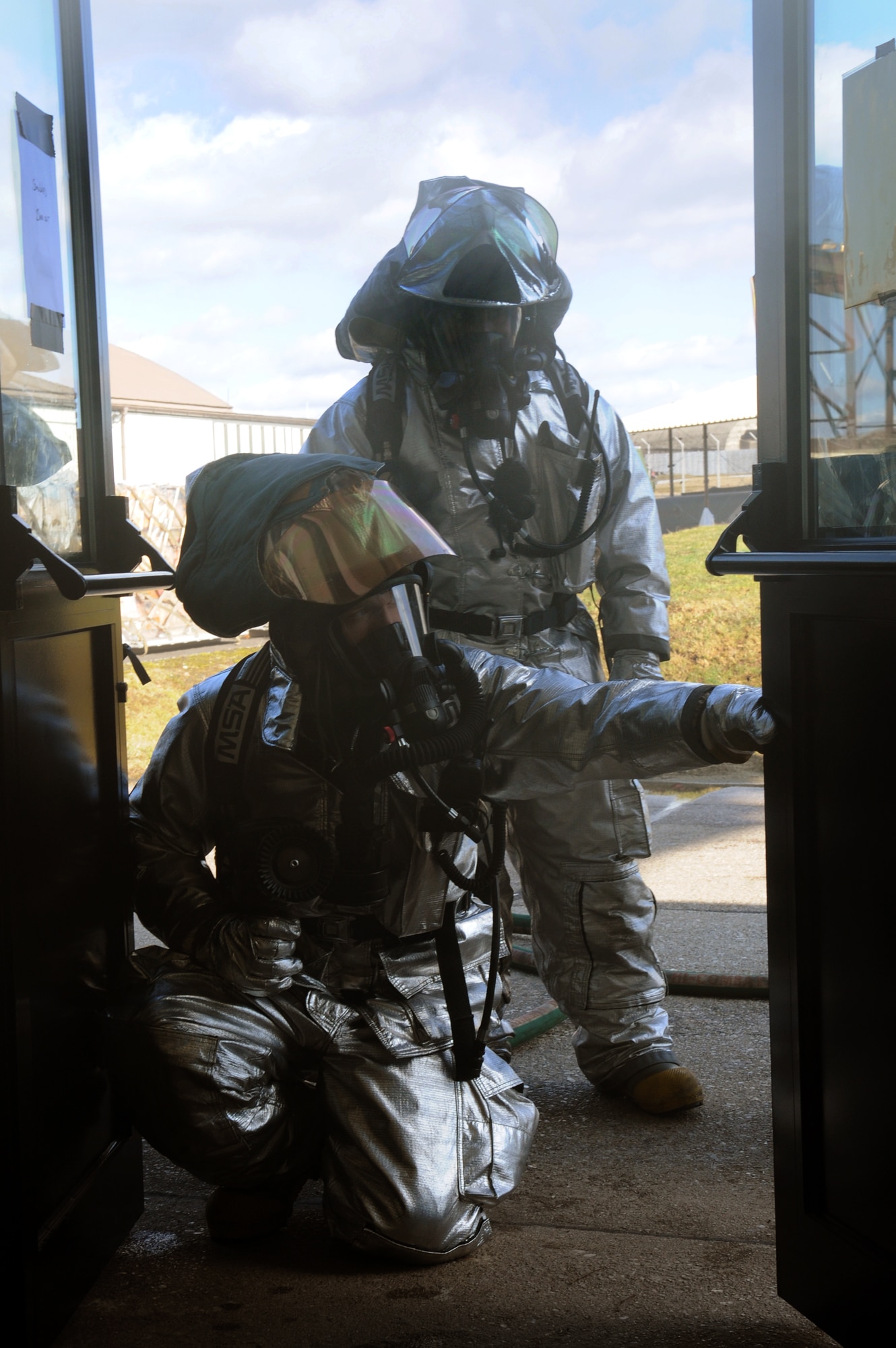 SPANGDAHLEM AIR BASE, Germany – Firefighters from the 52nd Civil Engineer Squadron Fire Department prepare to enter a smoke-filled building during a simulated fire during Operation Saber Crown 10-04 here March 2. Members of the 52nd Fighter Wing participated in the Phase II exercise to evaluate the wing’s ability to operate in a chemical, biological, radiological and nuclear environment. (U.S. Air Force photo/Senior Airman Nathanael Callon)