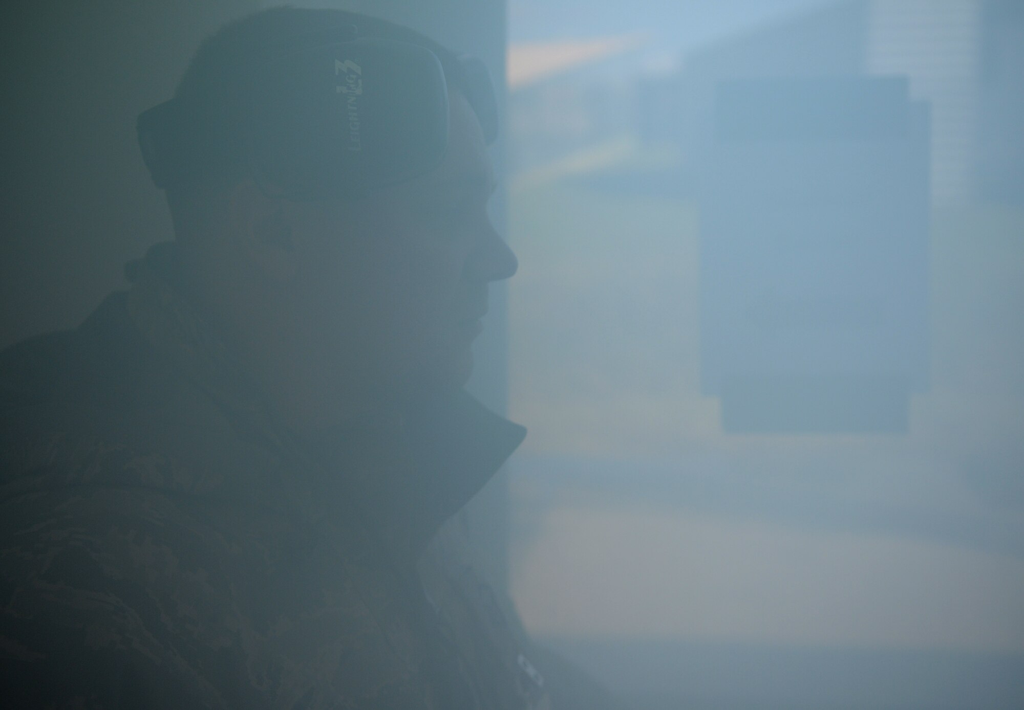 SPANGDAHLEM AIR BASE, Germany – A member of the Exercise Evaluation Team waits for the 52nd Civil Engineer Squadron Fire Department to respond to a smoke-filled building during a simulated fire during Operation Saber Crown 10-04 here March 2. EET members used a fog machine to fill the building with smoke and set the scene for the simulation. Members of the 52nd Fighter Wing participated in the Phase II exercise to evaluate the wing’s ability to operate in a chemical, biological, radiological and nuclear environment. (U.S. Air Force photo/Senior Airman Nathanael Callon)