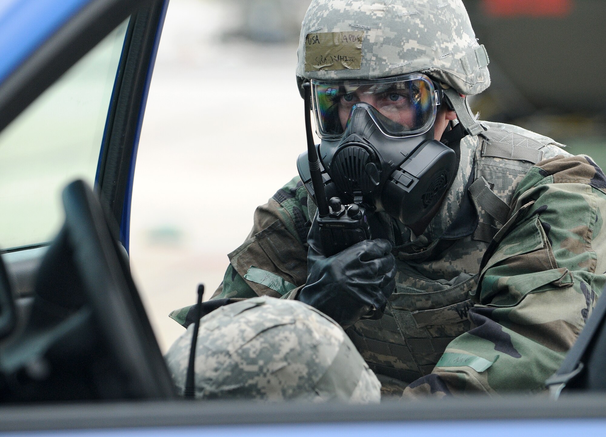 SPANGDAHLEM AIR BASE, Germany – Senior Airman Joseph White, 52nd Security Forces Squadron, contacts the Security Control Center after a simulated vehicle-borne improvised explosive device on the flightline here March 1. The simulation tested response to the attack and wear of chemical protective gear during Operation Saber Crown 10-04. (U.S. Air Force photo/Senior Airman Nathanael Callon)