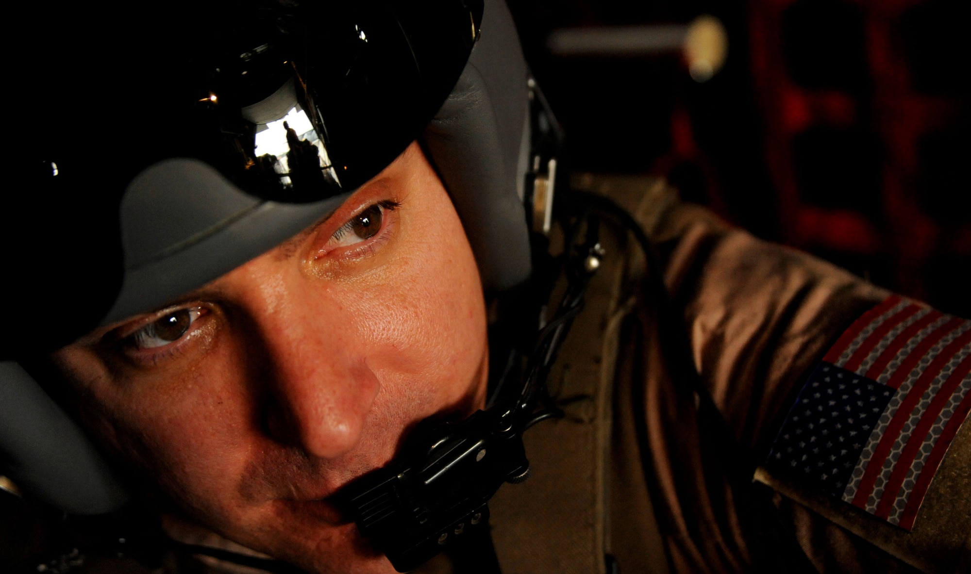 U.S. Air Force Tech. Sgt. Brian Miliefsky, loadmaster, 774th Expeditionary Airlift Squadron, deployed to Bagram Airfield, Afghanistan, watches as other loadmasters prepare for take-off on a C-130H Hercules, Feb. 6, 2010. This mission marked the first time an Air Force C-130 crew utilized low-cost low-altitude bundles in a combat zone.  (U.S. Air Force photo/Staff Sgt. Angelita Lawrence/released)
