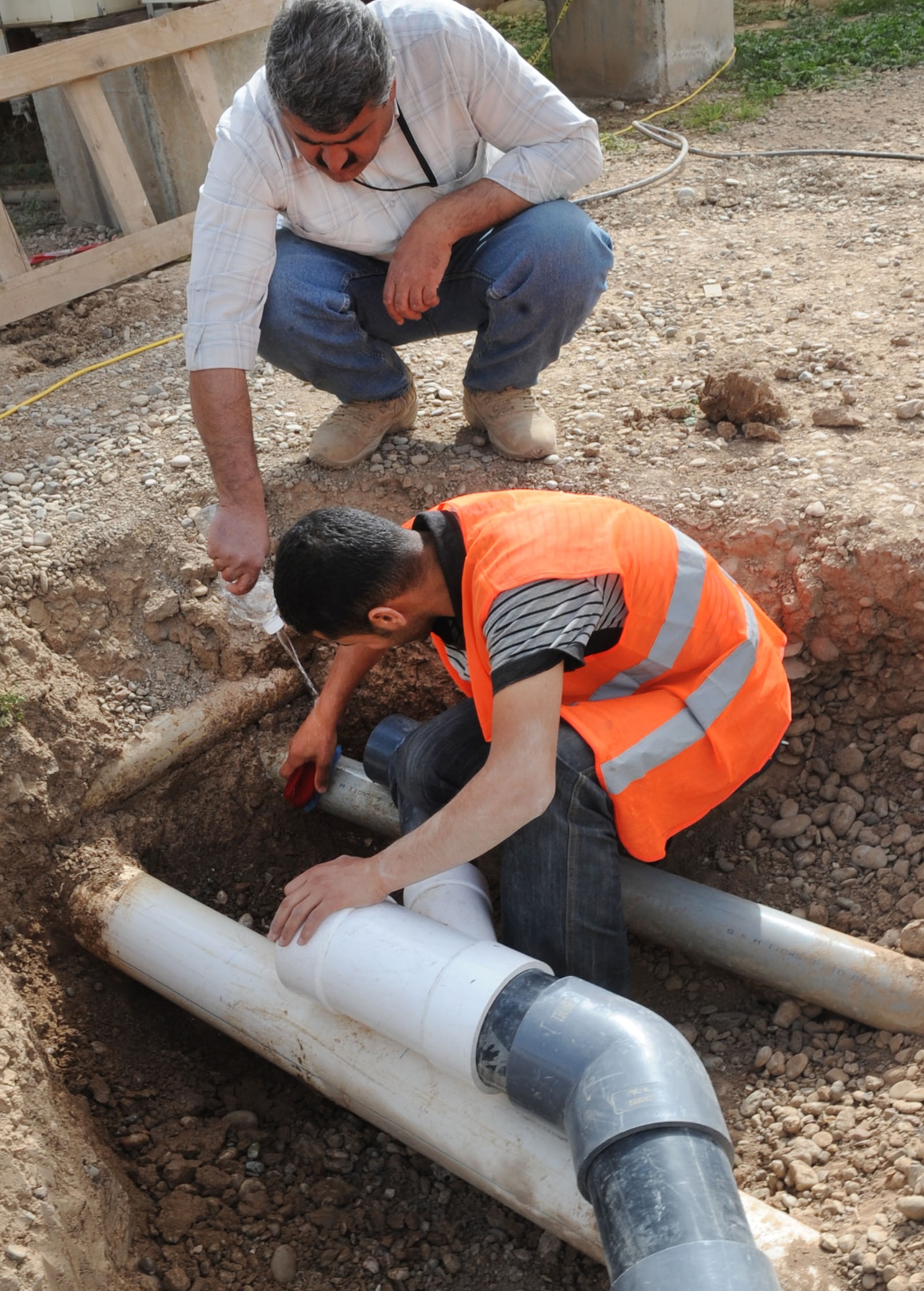 Crew members of Black Gold Holding Company, a local contractor, build a new lift station on Kirkuk Regional Air Base, Iraq on Feb. 24, 2010.  The crews constructed three new pump stations and modified five others.  As American forces drawdown the new lift station is one more positive sign Iraq has a bright future.  (U.S. Air Force photo/Staff Sgt. Tabitha Kuykendall/Released)	       