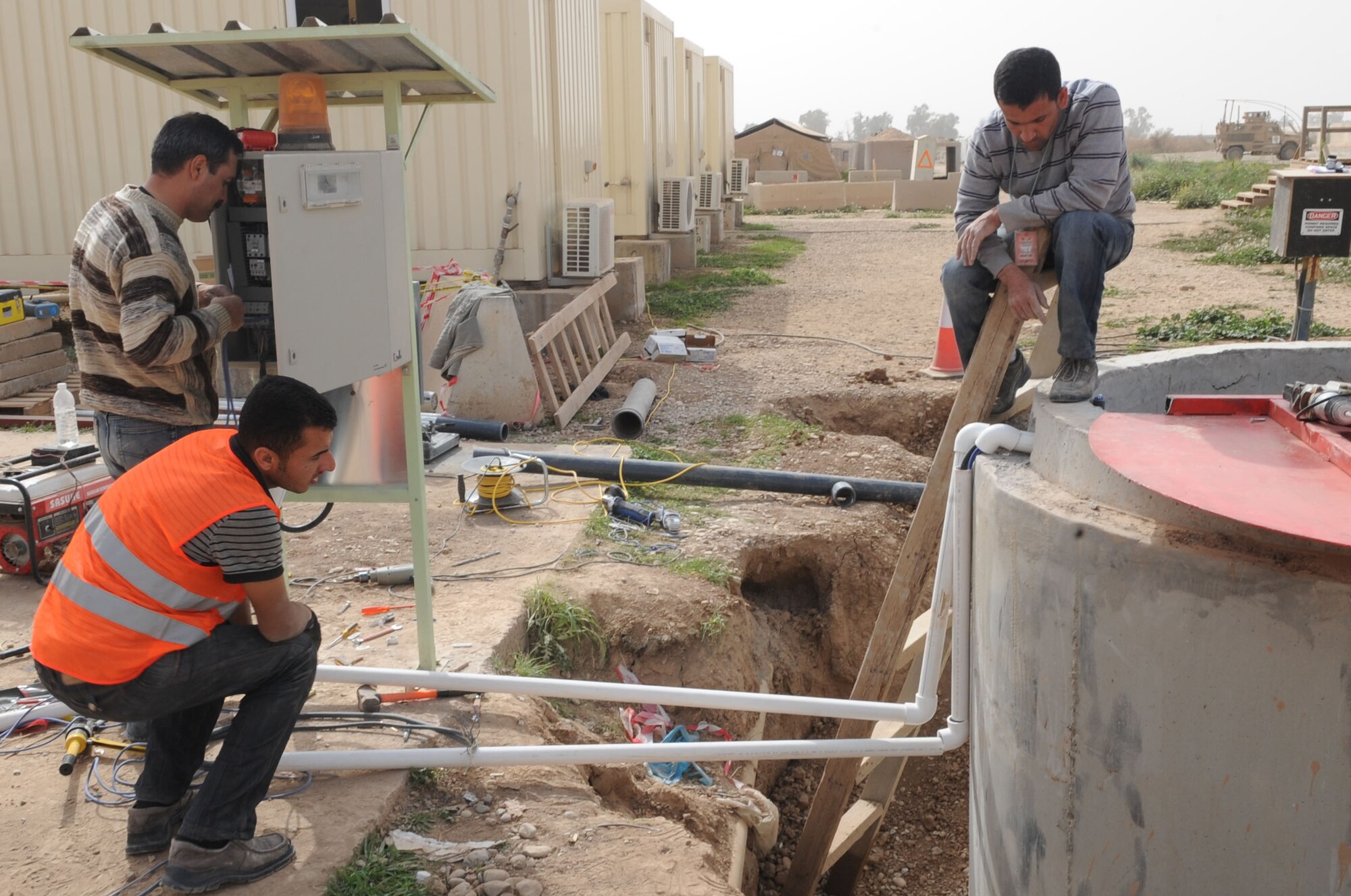 Crew members of Black Gold Holding Company, a local contractor, build a new lift station on Kirkuk Regional Air Base, Iraq on Feb. 24, 2010.  The crews constructed three new pump stations and modified five others.  As American forces drawdown the new lift station is one more positive sign Iraq has a bright future.  (U.S. Air Force photo/Staff Sgt. Tabitha Kuykendall/Released)	       