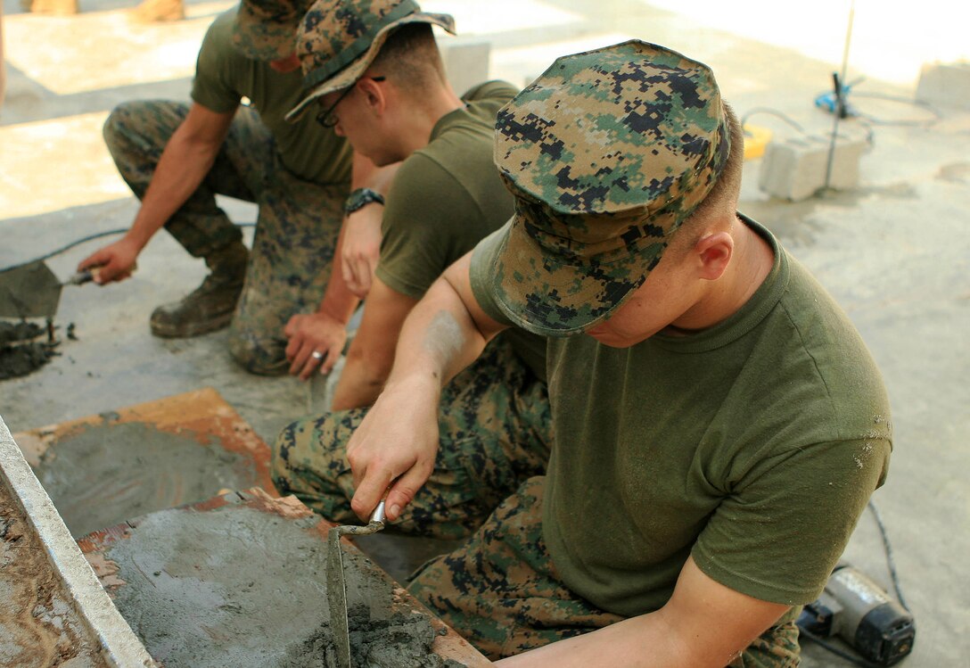 Marines with Combat Logistic Battalion 31 (CLB-31), 31st Marine Expeditionary Unit (MEU), repair a school wall with cement during an engineering civil affairs project (ENCAP), March 5. Marines and sailors with CLB-31 are rebuilding a two-room classroom at Marnay Primary School during exercise Balikatan 2010 (BK ’10). Armed Forces of the Philippines (AFP) and the U.S. are working together during BK ’10 to hone their civil-military interoperability skills to ensure more responsive, efficient and effective relief efforts. (Official Marine Corps photo by Lance Cpl. Dengrier M. Baez)