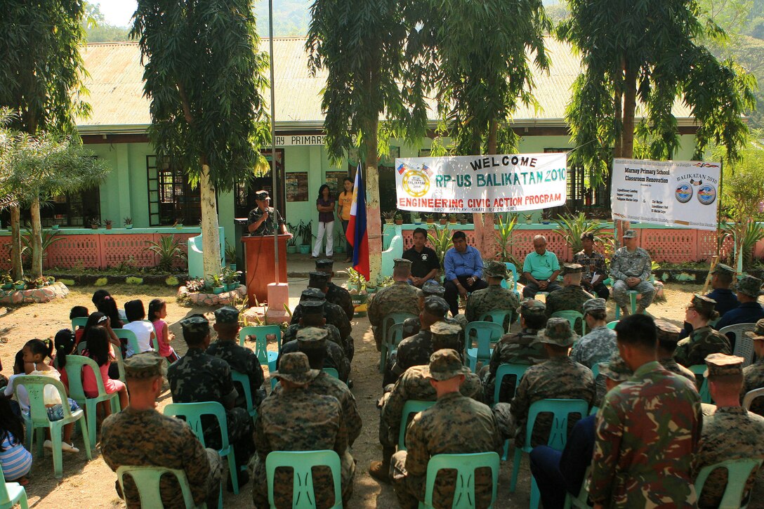 Members from the Armed Forces of the Philippines (AFP),  Marines and sailors with Combat Logistic Battalion 31 (CLB-31), 31st Marine Expeditionary Unit (MEU), and soldiers and sailors with the Joint Civil-Military Operations Task Force, attended an opening ceremony for an engineering civil affairs project (ENCAP), here, March 5. Marines and sailors with CLB-31 are rebuilding a two-room classroom at Marnay Primary School during exercise Balikatan 2010 (BK ’10). Armed Forces of the Philippines (AFP) and the U.S. are working together during BK ’10 to hone their civil-military interoperability skills to ensure more responsive, efficient and effective relief efforts. (Official Marine Corps photo by Lance Cpl. Dengrier M. Baez)