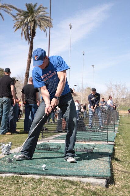 Lance Cpl. Andrew Lemley, a motor transportation mechanic for 3rd Combat Engineer Battalion, practices his swing at the Desert Winds Golf Course during 3rd CEB's family day March 5.