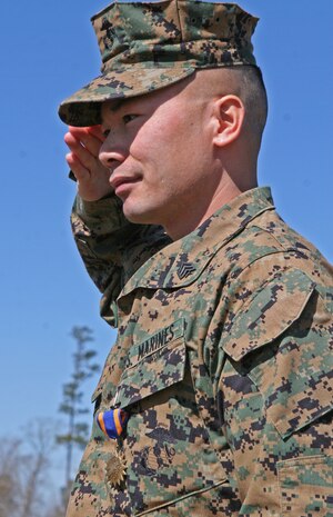 Sgt. Hong C. Deng, a field wireman with Combat Logistics Regiment 25, 2nd Marine Logistics Group, salutes after receiving an Air Medal (Strike/ Flight) during a ceremony held aboard Camp Lejeune, N.C., Mar. 5, 2010.  Deng received the medal for his actions while serving as the battle staff controller, a billet typically held by a staff noncommissioned officer, with Joint Airborne Battle Staff Detachment, Multi National Force – Iraq, from April 4, 2009 to May 15, 2009.  (U.S. Marine Corps photo by Lance Cpl. Melissa A. Latty)