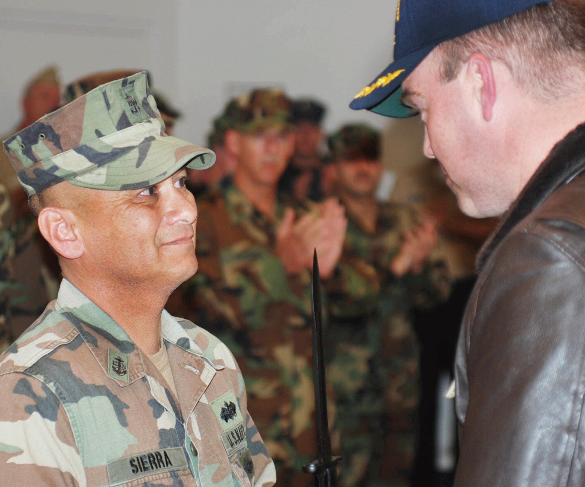 NOSC Moreno Valley commanding officer Cmdr. Dan Burns (right) presents the Colonel Millett Unit Excellence Award to Chief Petty Officer Ernest Sierra of CBMU 303, Det B, Feb. 21. The bayonet on the award honors the charge Col. Millett led during the Korean War, which is the last time such a charge has been used in battle. (U.S. Air Force photo by  Staff Sgt. Kevin Chandler)
