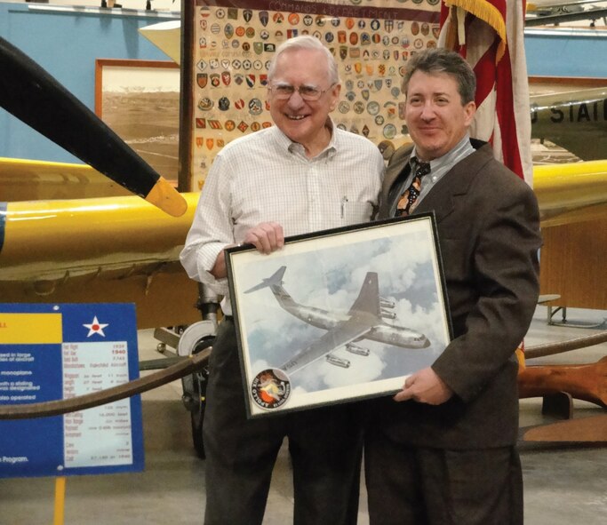 Harold Davis (left) donates a lithograph of a C-141 to the March Field Museum Feb. 9. The lithograph is signed by members of the Apollo 13 crew. Davis had helped with the transportation of the crew following their historic flight. (Photo courtesy of March Field Museum)