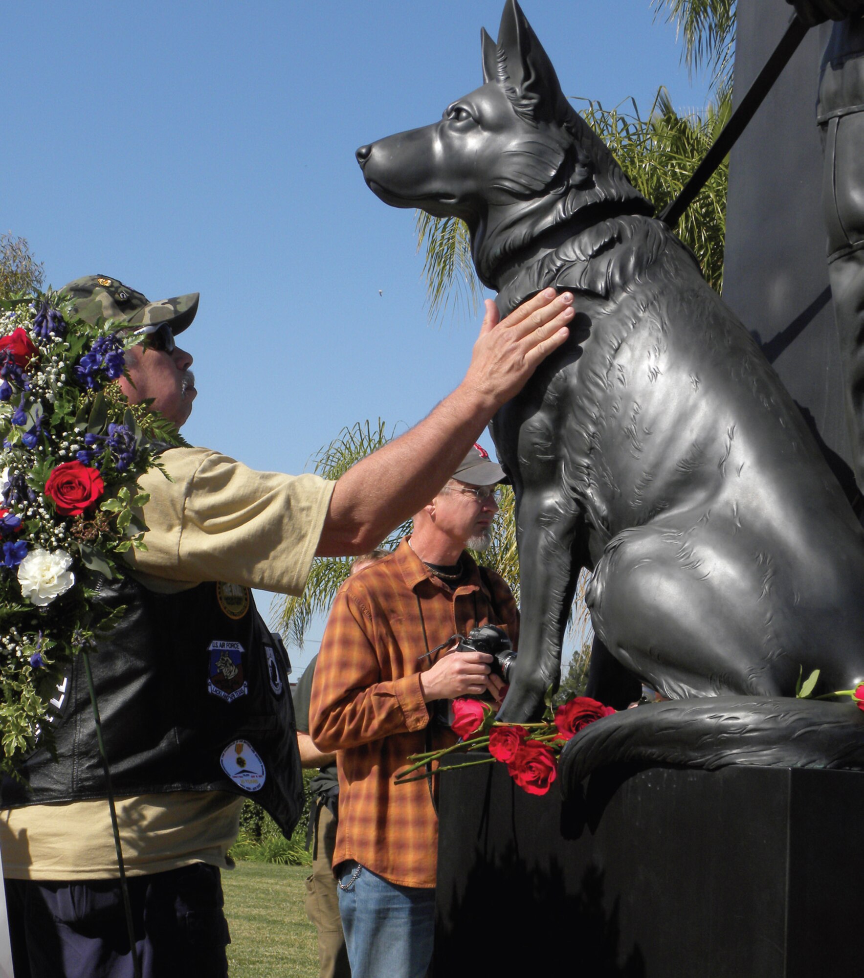 A veteran touches the War Dog memorial statue at the March Field Museum Feb. 13. The War Dog Memorial Fund hosted an event to commemorate the 10th anniversary of the statue. Speakers included Congressman Ken Calvert and retired Army Maj. Gen. Paul Eaton. The sculptor of the War Dog memorial, Thomas Schomberg, attended the event. Paul Trainor, a museum volunteer said there were over 800 people in attendance. (Photo courtesy of March Field Museum)
