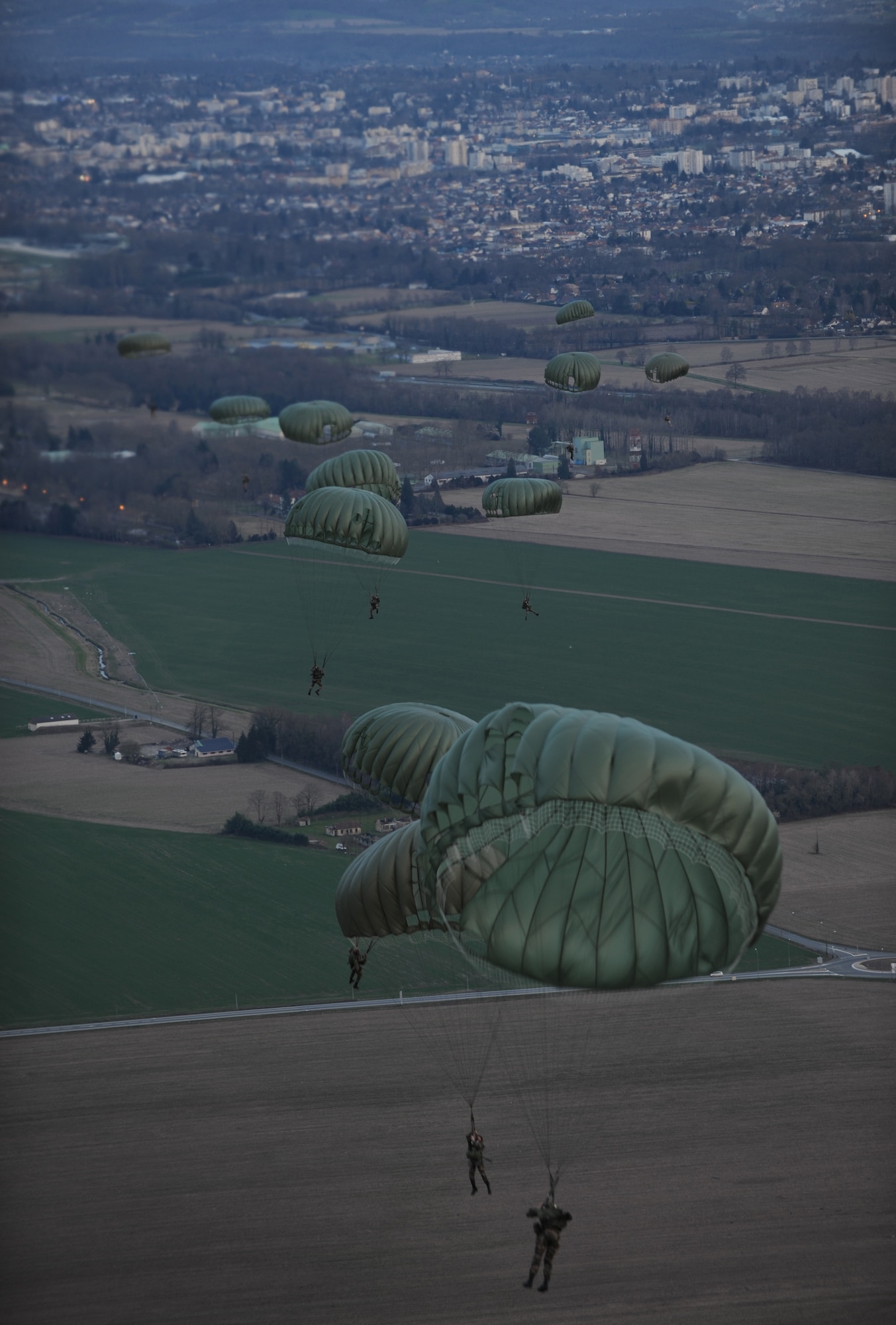 Airborne members from the 435th Contingency Response Group, 5th Quartermaster Company and the French Airborne jump from a C-130J Super Hercules at École des troupes aéroportées (ETAP) Pau, France, March 2, 2010. Members of the 435th Contingency Response Group and the 5th Quartermaster Company joined with their French military counterparts for a week of training at the École des troupes aéroportées es (ETAP), or School of Airborne Troops, a military school dedicated to training the military paratroopers  the French army, located in the town of Pau, in the département of Pyrénées-Atlantiques, France.  The ETAP is responsible for training paratroopers, and for international cooperation and promotion of paratroop culture. (U.S. Air Force photo by Airman 1st Class Caleb Pierce)