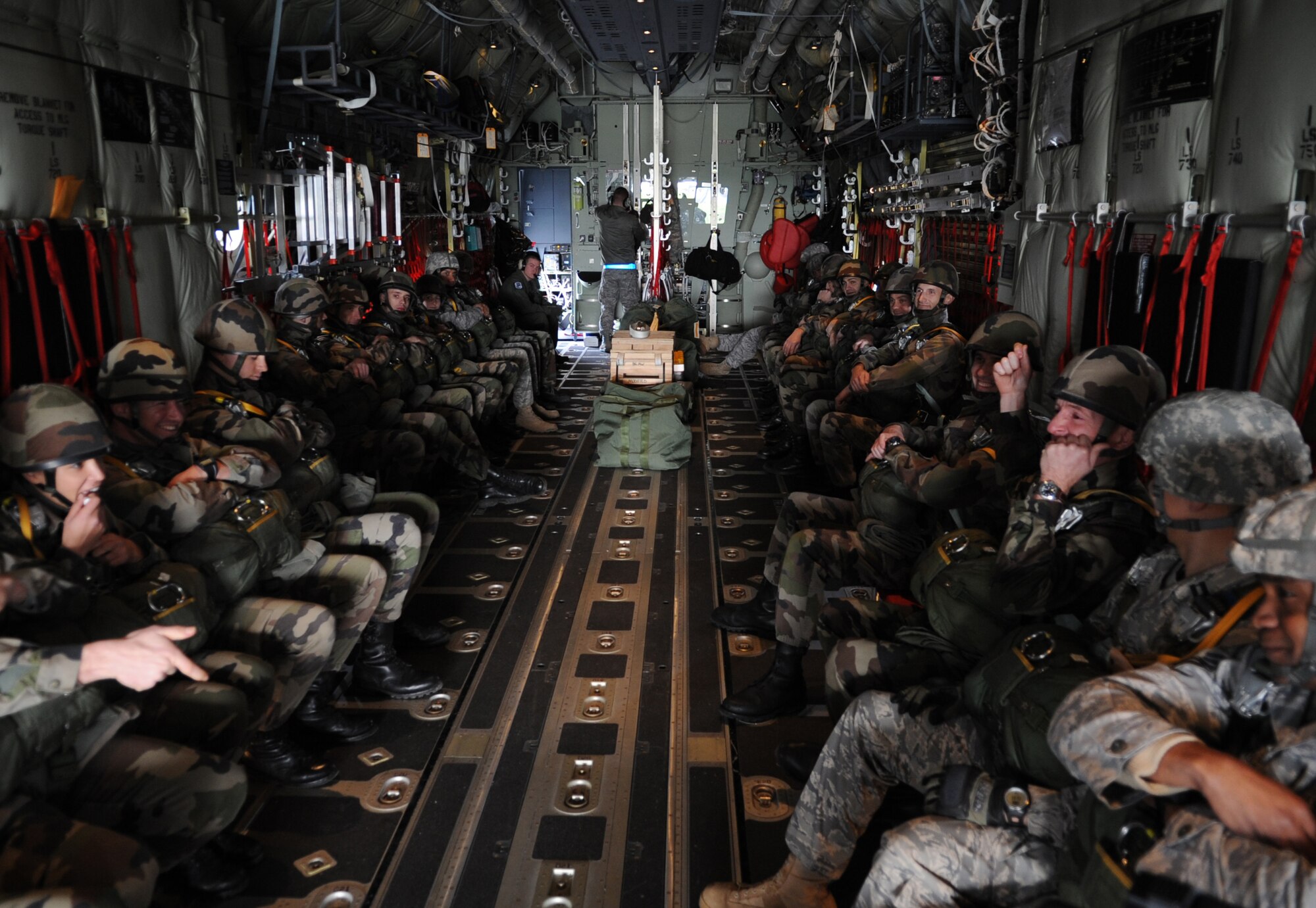 Airborne members from the 435th Contingency Response Group and the 5th Quartermaster Company sit on a C-130J Super Hercules for a static jump from a with the French Airborne military at École des troupes aéroportées (ETAP) Pau, France, March 2, 2010. Members of the 435th Contingency Response Group and the 5th Quartermaster Company joined with their French military counterparts for a week of training at the École des troupes aéroportées (ETAP), or School of Airborne Troops, a military school dedicated to training the military paratroopers  the French army, located in the town of Pau, in the département of Pyrénées-Atlantiques, France.  The ETAP is responsible for training paratroopers, and for international cooperation and promotion of paratroop culture. (U.S. Air Force photo by Airman 1st Class Caleb Pierce)