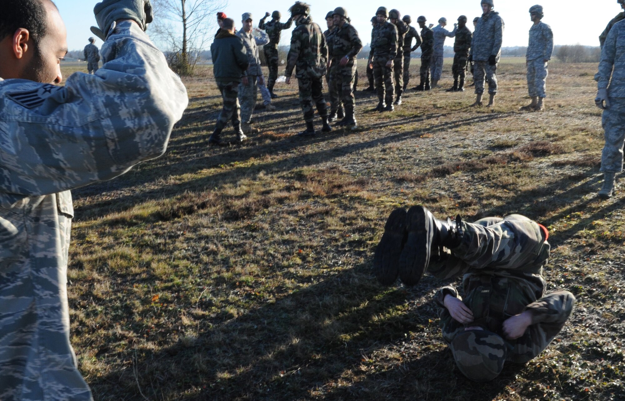 U.S. Air Force Staff Sgt. Myron Austin, 435th Security Forces Squadron, trains airborne members parachute landing fall training in preparation for a static jump from a C-130J Super Hercules with the French Airborne military at École des troupes aéroportées (ETAP) Pau, France, March 2, 2010. Members of the 435th Contingency Response Group and the 5th Quartermaster Company joined with their French military counterparts for a week of training at the École des troupes aéroportées (ETAP), or School of Airborne Troops, a military school dedicated to training the military paratroopers  the French army, located in the town of Pau, in the département of Pyrénées-Atlantiques, France.  The ETAP is responsible for training paratroopers, and for international cooperation and promotion of paratroop culture. (U.S. Air Force photo by Airman 1st Class Caleb Pierce)