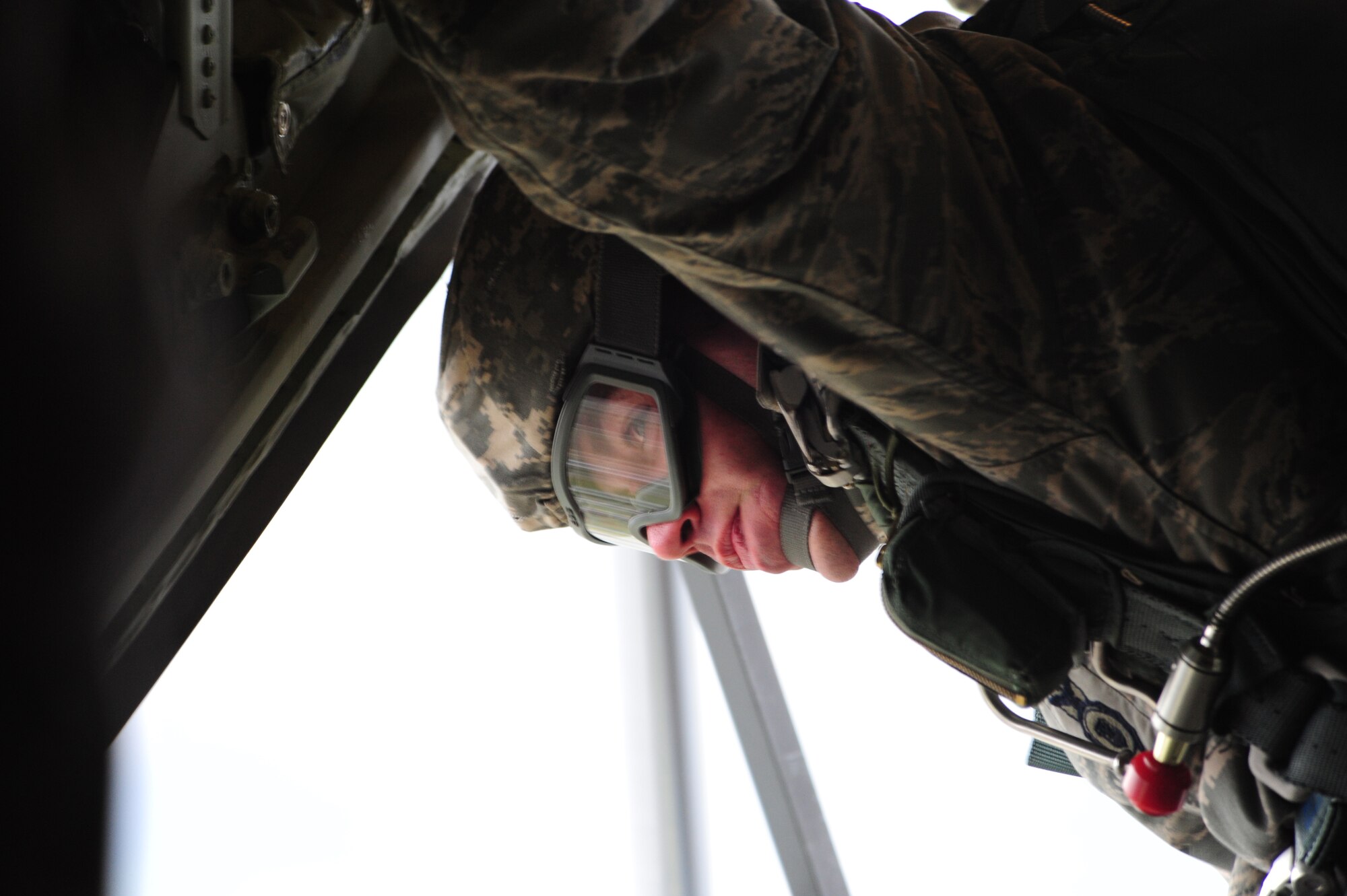 U.S. Air Force Tech. Sgt. Jason Shaffer from the 435th Security Forces Squadron, looks out the back of a C-130J as he prepares to lead his "stick" to include U.S. and French military members in a jump on March 3, 2010. Members of the 435th Contingency Response Group and the 5th Quartermaster Company joined with their French military counterparts for a week of training at the École des troupes aéroportées (ETAP), or School of Airborne Troops, a military school dedicated to training the military paratroopers   of the French army, located in the town of Pau, in the département of Pyrénées-Atlantiques, France.  The ETAP is responsible for training paratroopers, and for international cooperation and promotion of paratroop culture. (U.S. Air Force Photo by Staff Sgt. Jocelyn Rich)