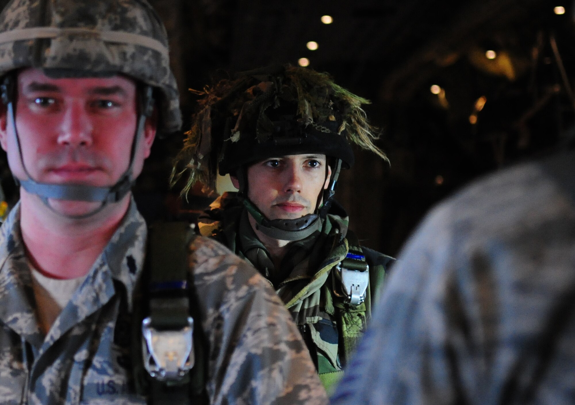 French Marine Major Pierre Prod'homme stands in anticipation of the green light to jump from a U.S. C-130J wearing a U.S. military parachute, March 3, 2010. Members of the 435th Contingency Response Group and the 5th Quartermaster Company joined with their French military counterparts for a week of training at the École des troupes aéroportées (ETAP), or School of Airborne Troops, a military school dedicated to training the military paratroopers   of the French army, located in the town of Pau, in the département of Pyrénées-Atlantiques, France.  The ETAP is responsible for training paratroopers, and for international cooperation and promotion of paratroop culture. (U.S. Air Force Photo by Staff Sgt. Jocelyn Rich)