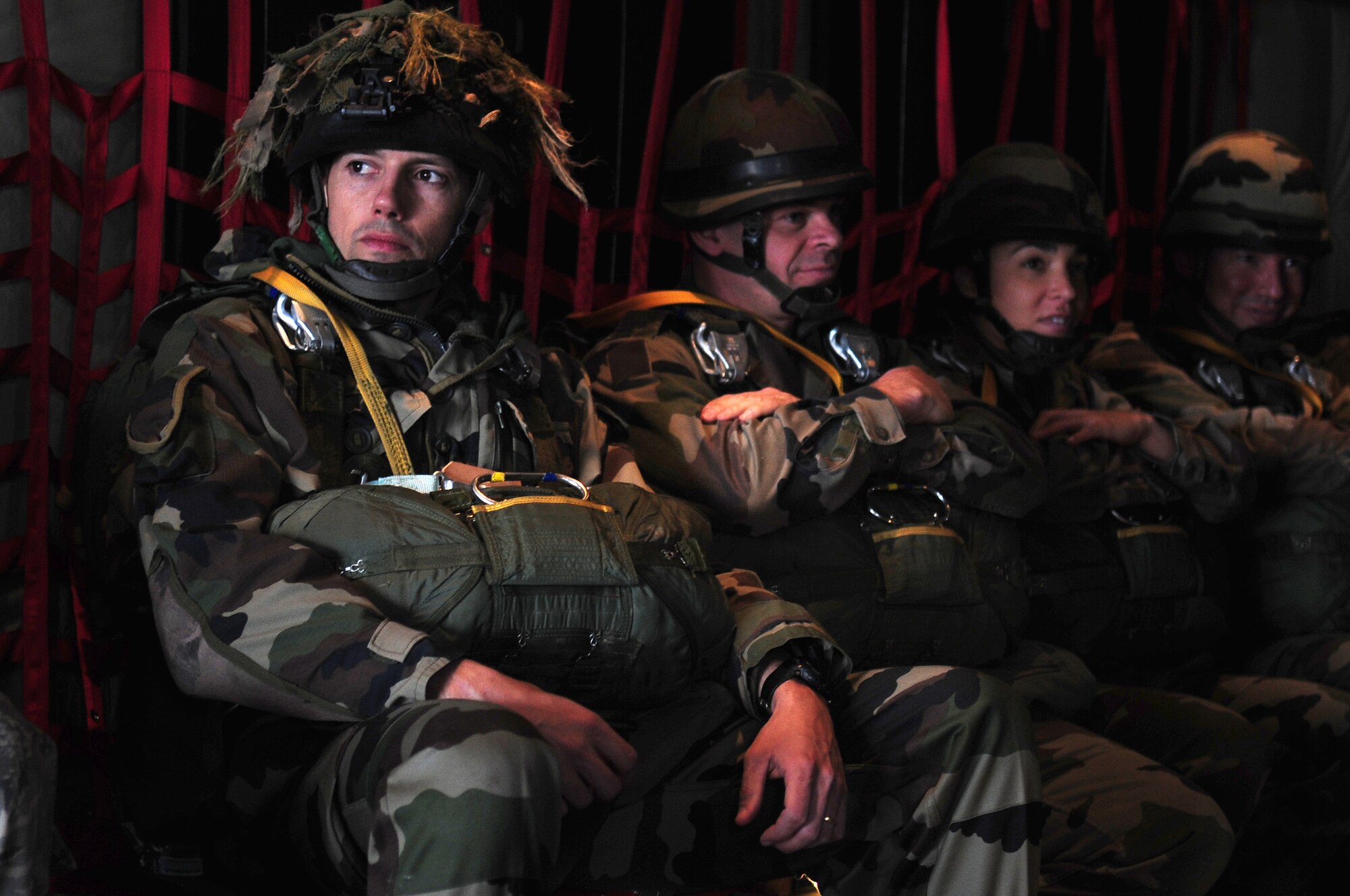 French Marine Major Pierre Prod'homme and French paratroopers wearing U.S. military parachutes await the green light for their jump on March 3, 2010. Members of the 435th Contingency Response Group and the 5th Quartermaster Company joined with their French military counterparts for a week of training at the École des troupes aéroportées (ETAP), or School of Airborne Troops, a military school dedicated to training the military paratroopers   of the French army, located in the town of Pau, in the département of Pyrénées-Atlantiques, France.  The ETAP is responsible for training paratroopers, and for international cooperation and promotion of paratroop culture. (U.S. Air Force Photo by Staff Sgt. Jocelyn Rich)