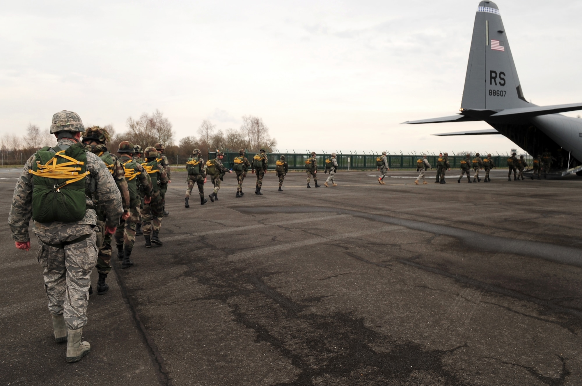 U.S. and French military members make their way to a U.S. Air Force C-130J in preparation for their jump, March 3, 2010.  Members of the 435th Contingency Response Group and the 5th Quartermaster Company joined with their French military counterparts for a week of training at the École des troupes aéroportées (ETAP), or School of Airborne Troops, a military school dedicated to training the military paratroopers   of the French army, located in the town of Pau, in the département of Pyrénées-Atlantiques, France.  The ETAP is responsible for training paratroopers, and for international cooperation and promotion of paratroop culture. (U.S. Air Force Photo by Staff Sgt. Jocelyn Rich)