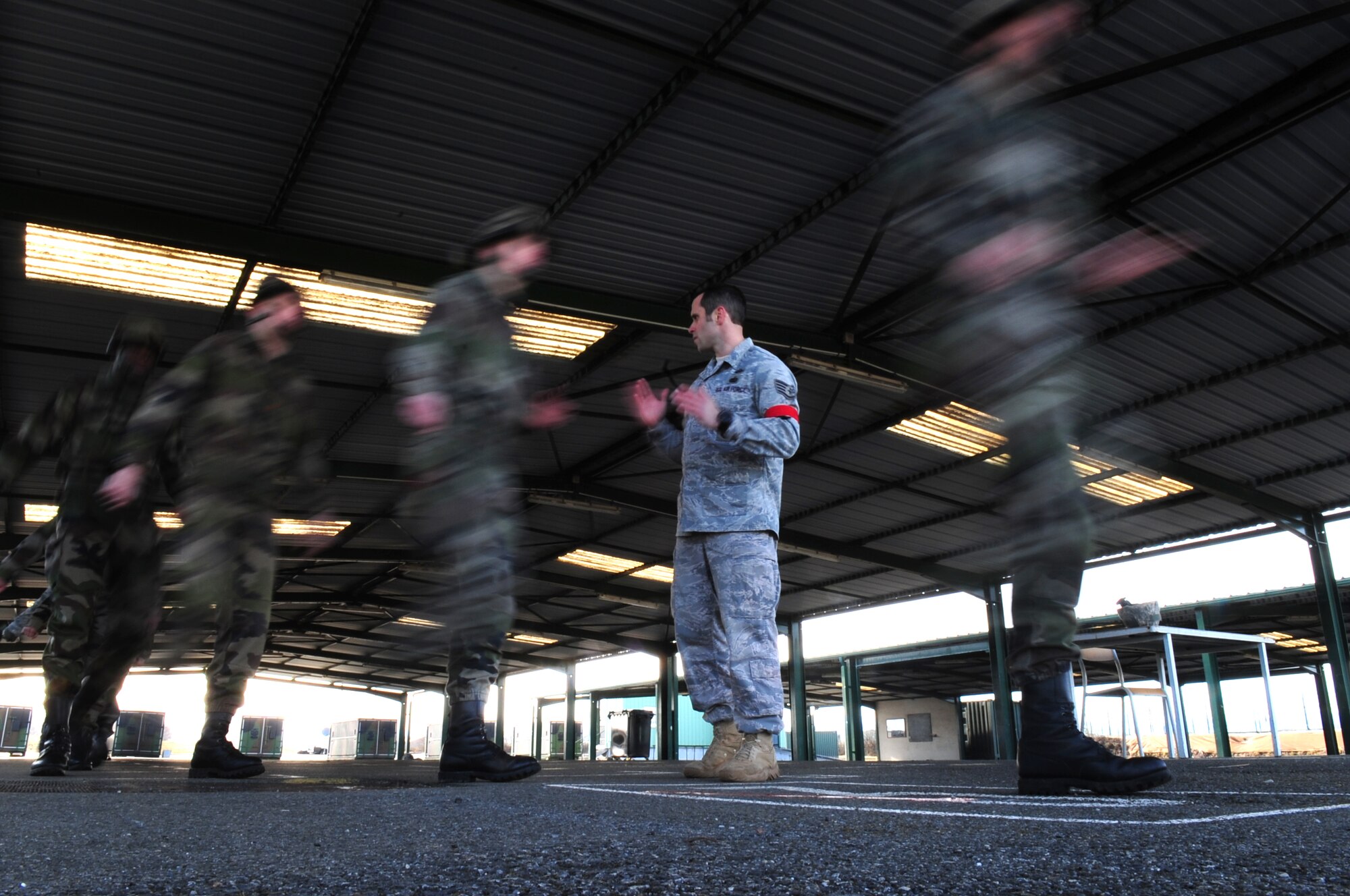 U.S. Air Force Staff Sgt. Joseph Klimaski from the 435th Security Forces Squadron goes through proper exiting procedures with members of the French military in preparation for a jump from a U.S. aircraft using U.S. equipment, March 2, 2010.  Members of the 435th Contingency Response Group and the 5th Quartermaster Company joined with their French military counterparts for a week of training at the École des troupes aéroportées (ETAP), or School of Airborne Troops, a military school dedicated to training the military paratroopers   of the French army, located in the town of Pau, in the département of Pyrénées-Atlantiques, France.  The ETAP is responsible for training paratroopers, and for international cooperation and promotion of paratroop culture. (U.S. Air Force Photo by Staff Sgt. Jocelyn Rich)