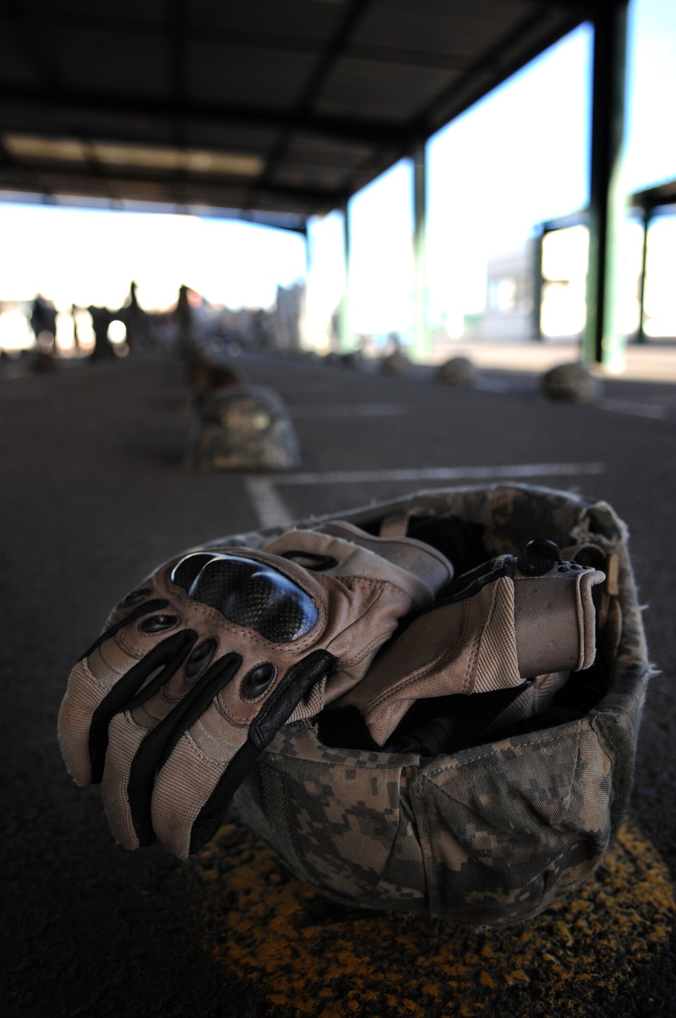 A pair of gloves rest in a helmet while members of the French and U.S. military review proper jump procedures using U.S. military equipment on March, 2, 2010.  Members of the 435th Contingency Response Group and the 5th Quartermaster Company joined with their French military counterparts for a week of training at the École des troupes aéroportées (ETAP), or School of Airborne Troops, a military school dedicated to training the military paratroopers   of the French army, located in the town of Pau, in the département of Pyrénées-Atlantiques, France.  The ETAP is responsible for training paratroopers, and for international cooperation and promotion of paratroop culture. (U.S. Air Force Photo by Staff Sgt. Jocelyn Rich)