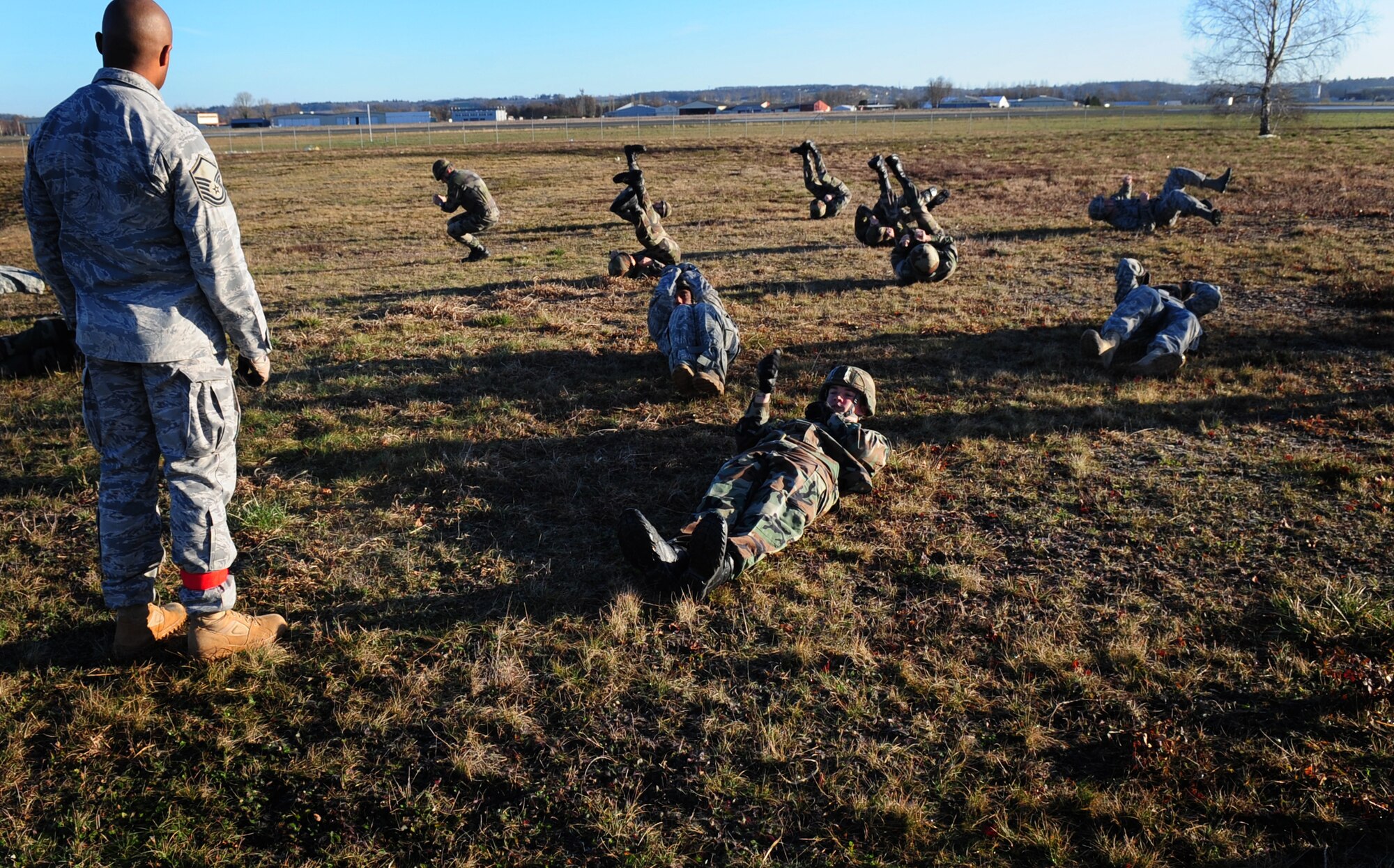 U.S. Air Force Master Sgt. James Turner with the 435 Security Forces Squadron, conducts training with U.S. and French military members on the proper form for landing from a parachute jump on March 2, 2010. Members of the 435th Contingency Response Group and the 5th Quartermaster Company joined with their French military counterparts for a week of training at the École des troupes aéroportées (ETAP), or School of Airborne Troops, a military school dedicated to training the military paratroopers   of the French army, located in the town of Pau, in the département of Pyrénées-Atlantiques, France.  The ETAP is responsible for training paratroopers, and for international cooperation and promotion of paratroop culture. (U.S. Air Force Photo by Staff Sgt. Jocelyn Rich) 