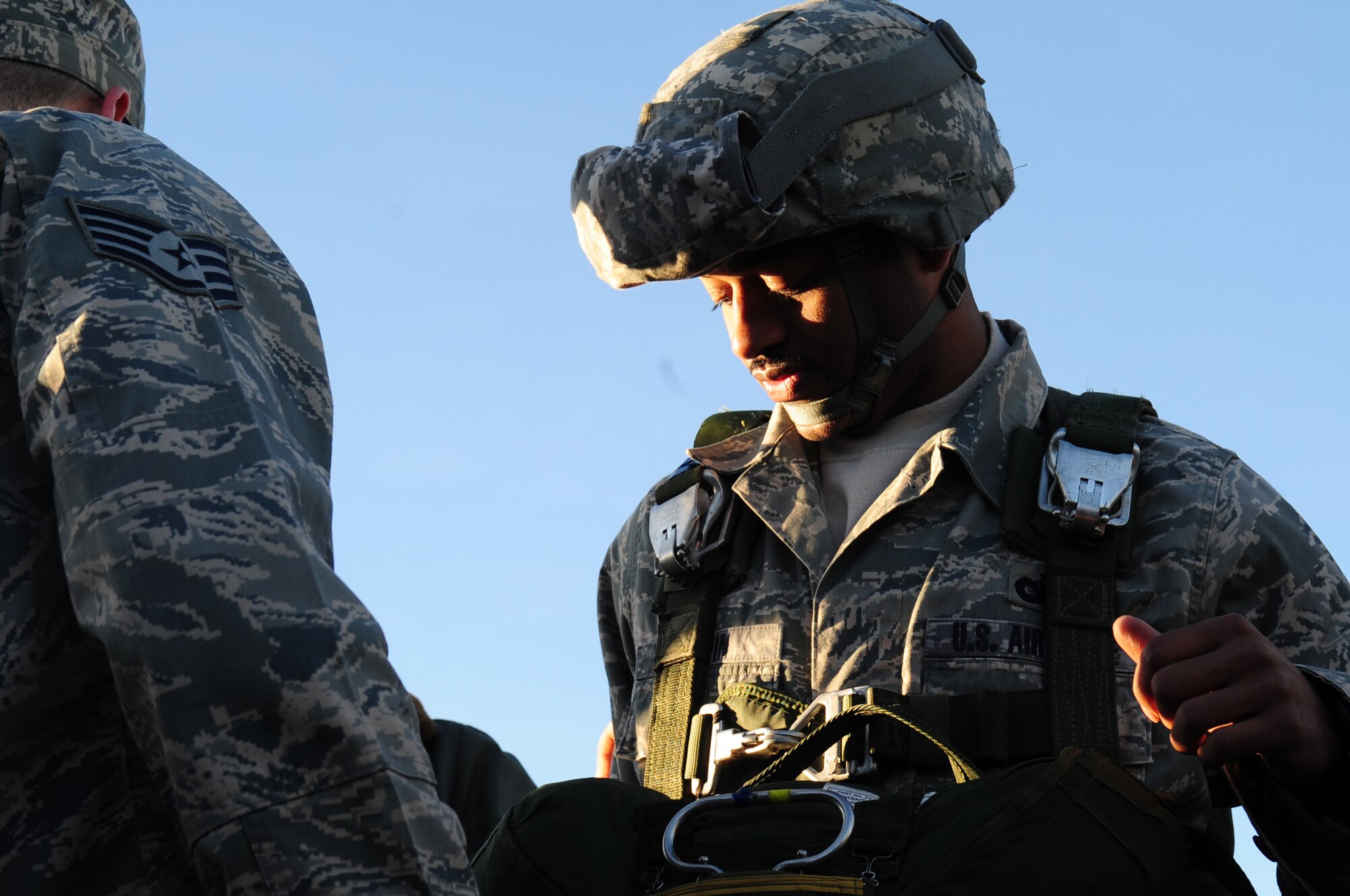 U.S. Air Force Staff Sgt. Myron Austin, with the 435th Security Forces Squadron, demonstrates the proper wear of a U.S. military parachute to French military members on March 2, 2010. Members of the 435th Contingency Response Group and the 5th Quartermaster Company joined with their French military counterparts for a week of training at the École des troupes aéroportées (ETAP), or School of Airborne Troops, a military school dedicated to training the military paratroopers, of the French army, located in the town of Pau; in the département of Pyrénées-Atlantiques, France. The ETAP is responsible for training paratroopers, and for international cooperation and promotion of paratroop culture. (U.S. Air Force Photo by Staff Sgt. Jocelyn Rich)