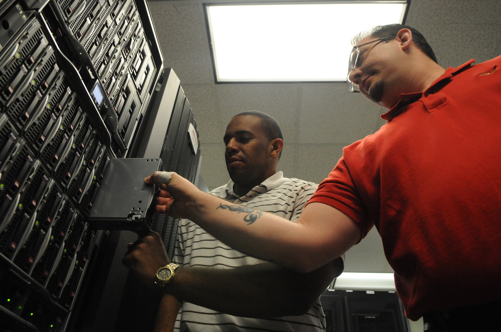 Adrian McLure (right) and Keith Epson, 902nd Communications Squadron, prepare the equipment to be used for the upcoming e-mail migration on Randolph. (U.S. Air Force photo by Rich McFadden)