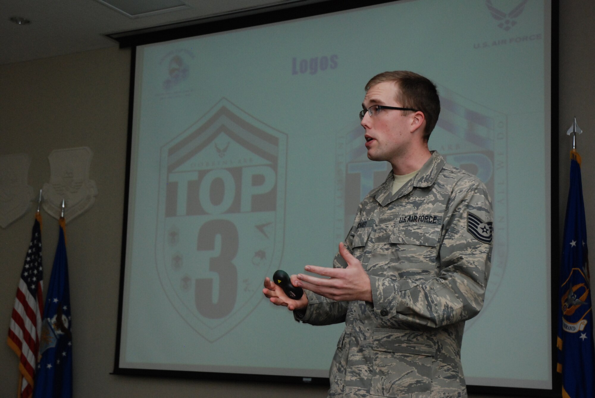 Tech. Sgt. Christian Michael, 22nd Air Force Public Affairs NCO, discusses new logo change possibilities for Dobbins Top Three Association at the February UTA meeting.  (U.S. Air Force photo/Master Sgt. Stan Coleman)