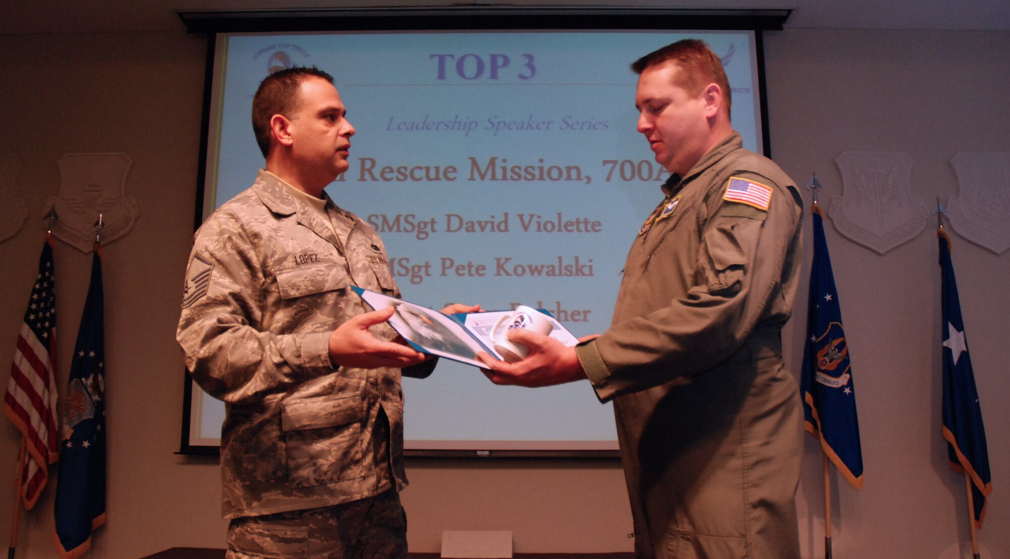 Master Sgt. Larry Lopez, Dobbins Top Three Association president, presents a certificate of appreciation to Master Sgt. Pete Kowalski, 700th Airlift Squadron loadmaster and instructor, for his presentation on his experiences during the Haiti earthquake relief effort.  The 700th Airlift Squadron provided C-130 airlift support during Operation Unified Response Jan. 17-22.  (U. S. Air Force photo/Master Sgt. Stan Coleman)

  (U.S. Air Force photo/Master Sgt. Stan Coleman)