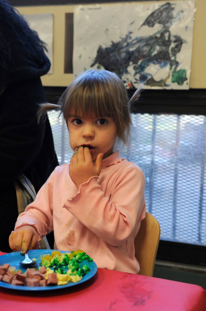 Kaitlyn Gerrie, a Randolph Air Force Base Child Development Center 2-year-old,  enjoys her breakfast of green eggs and ham at the CDC in recognition of Dr. Suess' birthday. (U.S. Air Force Photo by Steve White)