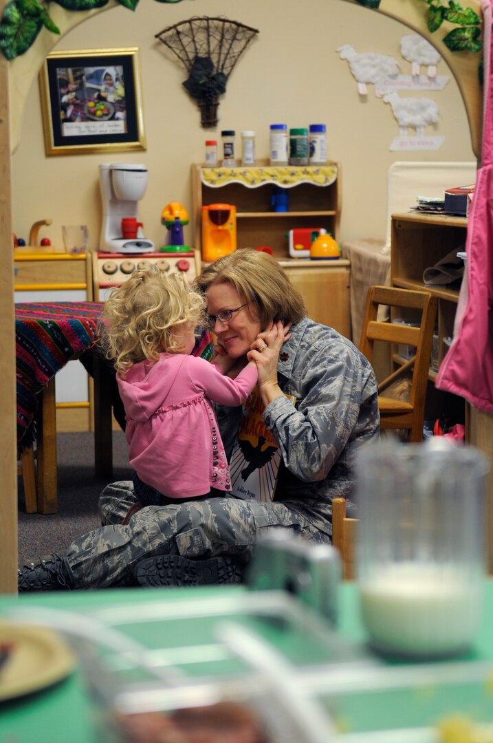 Maj. Suzannah Simone, 359th Medical Group from Randolph Air Force Base, TX, enjoys some personal time with daughter, Virginia, at the Child Development Center. (U.S. Photo by Steve White)