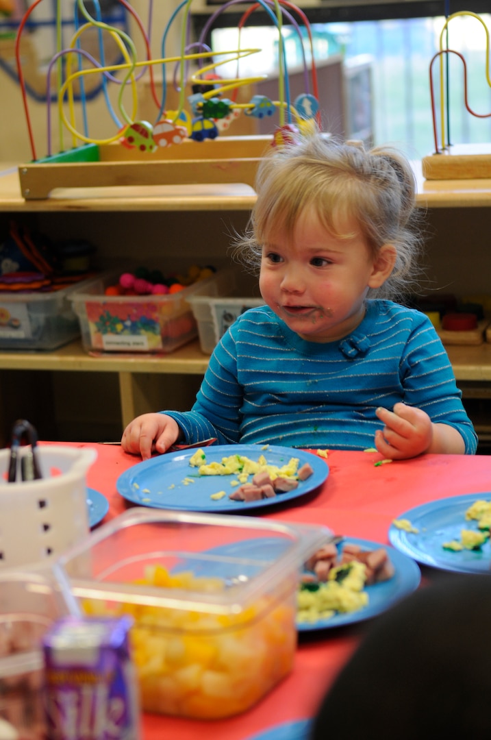 Bailee Prather, a Randolph Air Force Base Child Development Center 2-year-old,  enjoys her breakfast of green eggs and ham at the CDC in recognition of Dr. Suess' birthday. (U.S. Air Force Photo by Steve White)