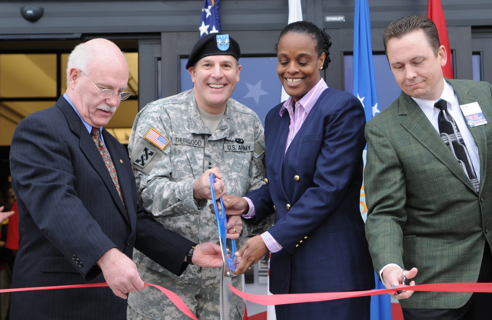 Doors to the new Randolph Air Force Base Exchange opened March 5, with a ribbon cutting ceremony. Event officials cutting the ribbon are (L-R), Robert Graves, Army Maj. Gen. Keith Thurgood, Army and Air Force Exchange Service commander, Shelly Armstrong, and Mike Einer. The new Building is AAFES' first environmentally friendly "green" BX, using energy-effecient glass, lighting, 40 percent recycled material carpet, and HVAC system to reduce the overall operating cost.(U.S. Air Force Photo By Don Lindsey)