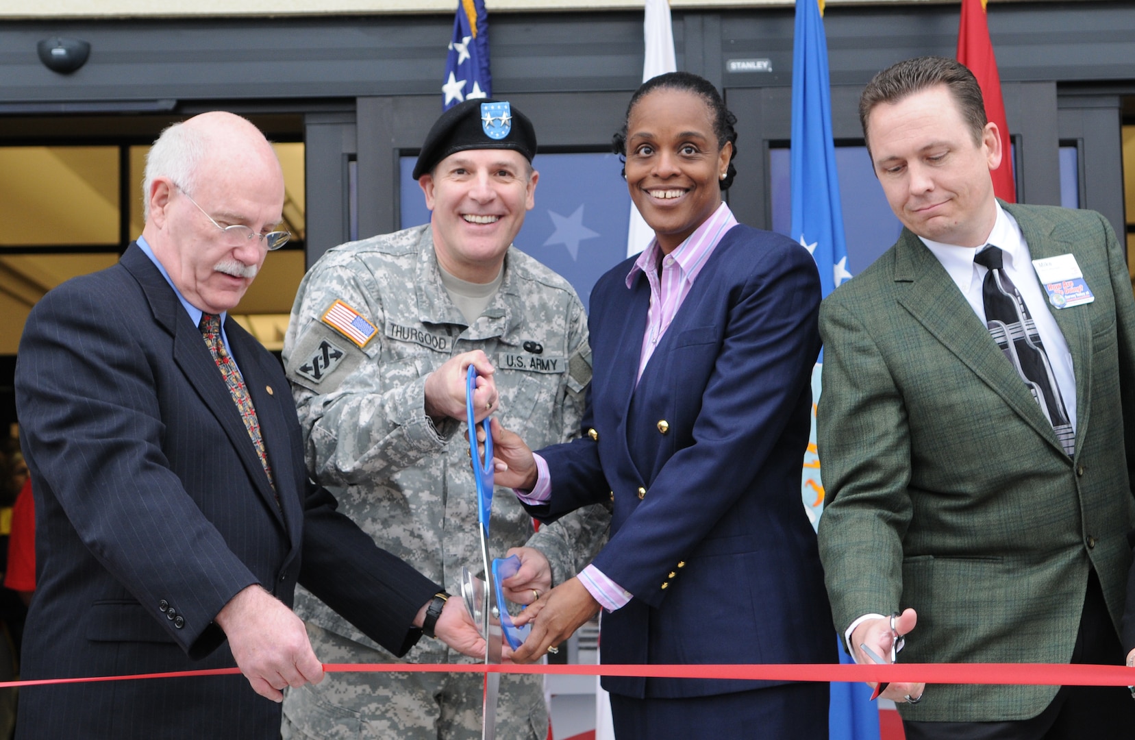 Doors to the new Randolph Air Force Base Exchange opened March 5, with a ribbon cutting ceremony. Event officials cutting the ribbon are (L-R), Robert Graves, Army Maj. Gen. Keith Thurgood, Army and Air Force Exchange Service commander, Shelly Armstrong, and Mike Einer. The new Building is AAFES' first environmentally friendly "green" BX, using energy-effecient glass, lighting, 40 percent recycled material carpet, and HVAC system to reduce the overall operating cost.(U.S. Air Force Photo By Don Lindsey)