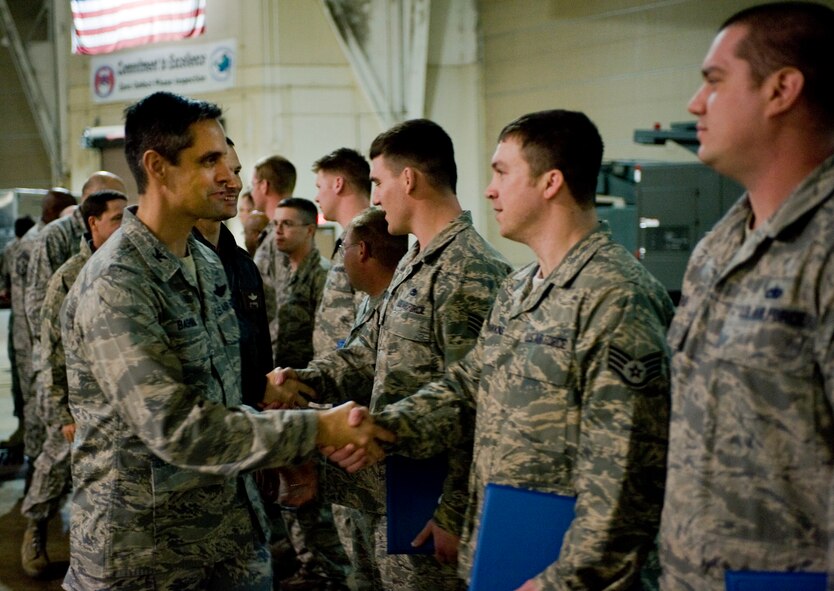 BARKSDALE AIR FORCE BASE, La. -- Col. Steven Basham, 2d Bomb Wing commander, congratulates Airmen who were appointed as Dedicated Crew Chiefs Feb. 26. The DCC program assigns top maintainers to oversee all maintenance of a specific aircraft. (U.S. Air Force photo by Airman 1st Class Chad Warren) (RELEASED)