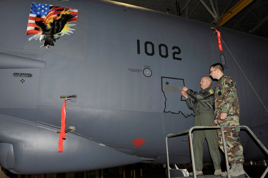 BARKSDALE AIR FORCE BASE, La. -- Col. Gregory Smith, 2d Operations Group commander, reveals the name of Staff Sgt. Ryan Bloor, appointing him Dedicated Crew Chief of the 2d OG flagship aircraft Feb. 26. The DCC program assigns top maintainers to oversee all maintenance of a specific aircraft. (U.S. Air Force photo by Airman 1st Class Chad Warren) (RELEASED)