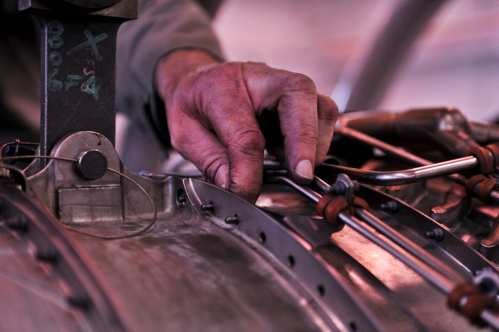 ELMENDORF AIR FORCE BASE, Alaska – Chris Hudson, a mechanic from 3rd Component Maintenance Squadron Propulsion Flight, works on a F-100 engine March 2.  The F-100 is used in Elmendorf’s F-15 Eagles and is valued at an estimated $3.2 million. (Air Force photo by Airman 1st Class Christopher Gross)