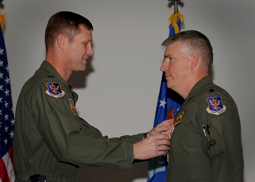 MOODY AIR FORCE BASE, Ga. -- Col. Gary Henderson, 23rd Wing commander, presents Lt. Col. Philip Wielhouwer, 23rd Fighter Group deputy commander, with the Bronze Star Medal during a commander’s call here March 5. While deployed, Colonel Wielhouwer commanded the 74th Expeditionary Fighter Squadron, Bagram Airfield, Afghanistan. (U.S. Air Force photo by Senior Airman Gina Chiaverotti-Paige)
