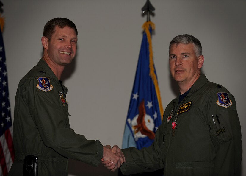 MOODY AIR FORCE BASE, Ga. -- Col. Gary Henderson, 23rd Wing commander, congratulates Lt. Col. Philip Wielhouwer, 23rd Fighter Group deputy commander, after presenting him with the Bronze Star Medal during a commander’s call here March 5. Colonel Wielhouwer led the projection of lethal airpower to eliminate Taliban and Al Qaeda terrorists throughout Afghanistan. (U.S. Air Force photo by Senior Airman Gina Chiaverotti-Paige)
