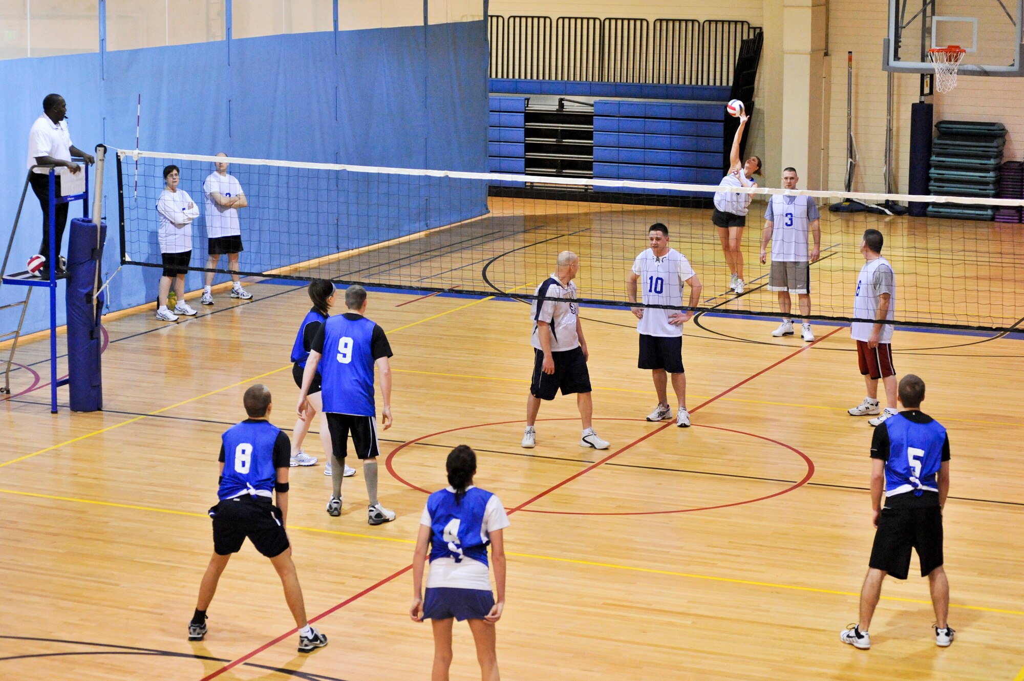 ELMENDORF AIR FORCE BASE, Alaska -- The 732nd Air Mobility Squadron serves the ball to the 3rd Security Forces Squadron during a game March 3, at Elmendorf’s Fitness Center. The 732nd AMS won two straight sets, with a score of 25-18 and 25-14, to win the matchup between the two teams during intramural play. (Air Force photo by Airman 1st Class Christopher Gross)
