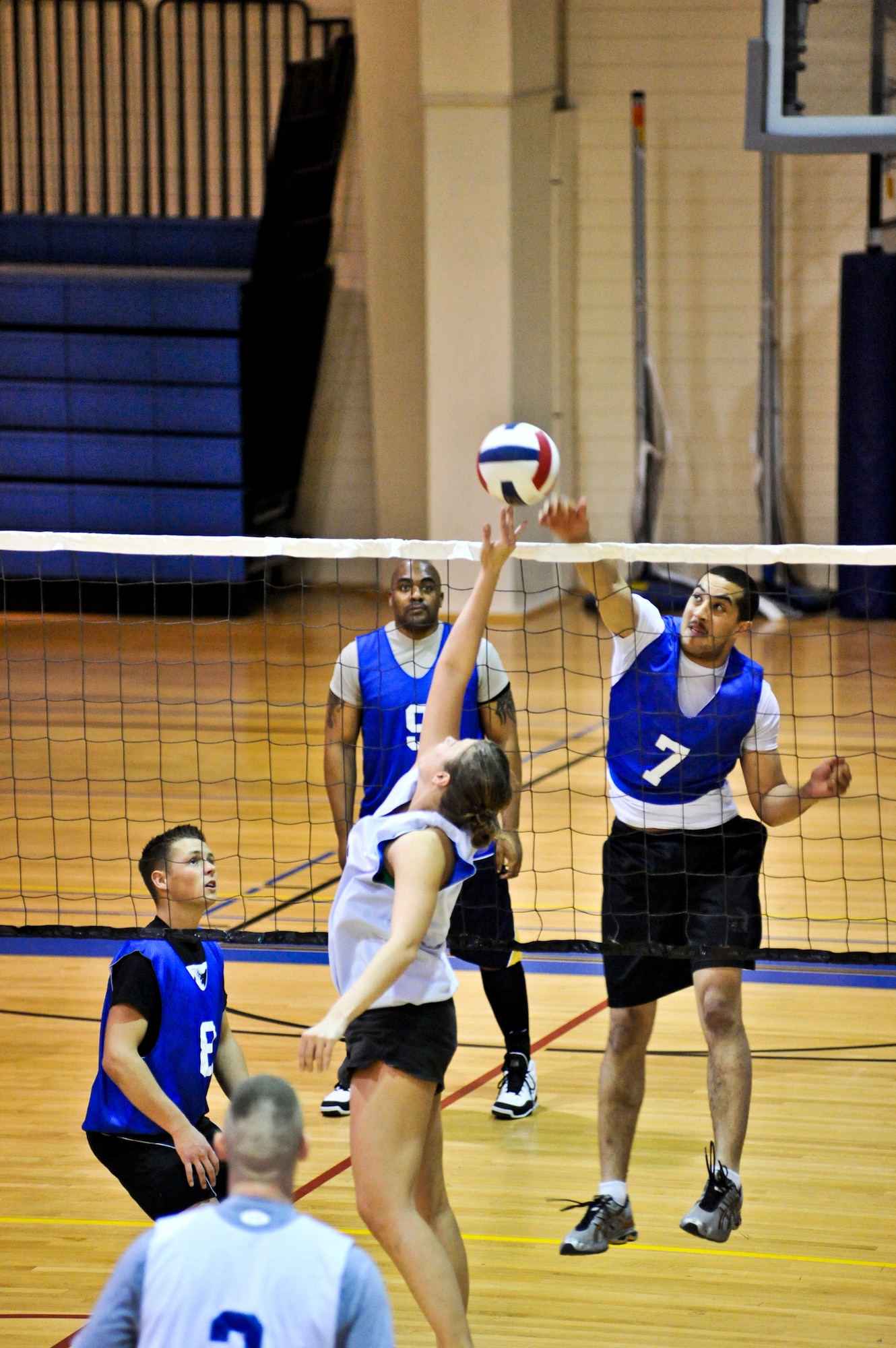 ELMENDORF AIR FORCE BASE, Alaska – A member from the 3rd Security Forces Squadron tips the volleyball back over the net during a game against the 732nd Air Mobility Squadron March 3, at Elmendorf’s Fitness Center. The 732nd AMS won two straight sets, with a score of 25-18 and 25-14, to win the matchup between the two teams during intramural play. (Air Force photo by Airman 1st Class Christopher Gross)