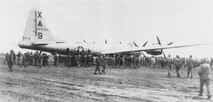 "Dinah Might," the first crippled B-29 to make an emergency landing on Iwo Jima during the fighting, is surrounded by Marines and Seabees on 4 March 1945.Department of Defense Photo (USMC) 112392 